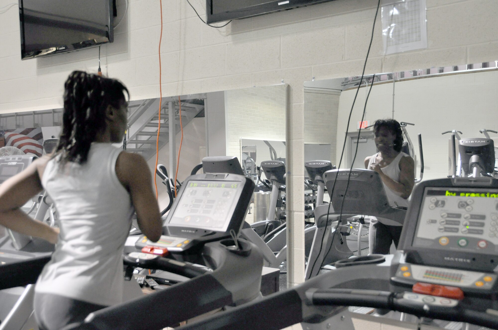 Tech. Sgt. Enid J Ellis runs on the treadmill in the Air Force Mortuary Affairs Operations fitness area. Sergeant J Ellis met her weight-loss goal during her deployment here. (U.S. Air Force photo/Christin Michaud)