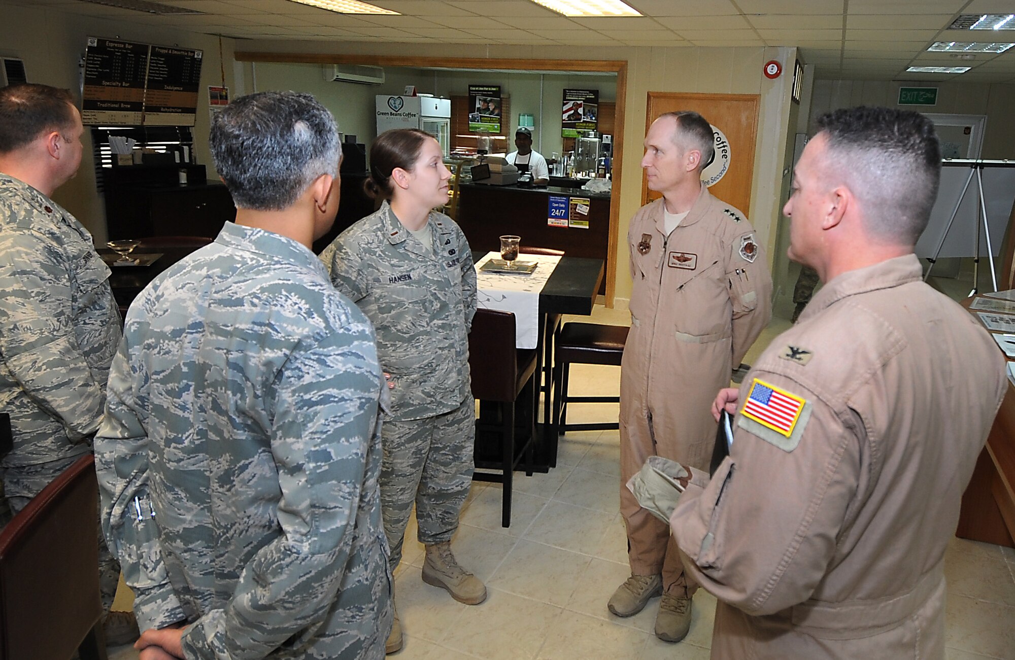 Lieutenant General Mike Hostage, U.S. Air Forces Central Command commander, second from right, talks with 2nd Lt. Shannan Hansen, 386th Expeditionary Force Support Squadron community services flight commander, Feb. 25 about the features of the Wired Cafe on base where Airmen can use wireless Internet to call home. General Hostage toured the base to talk with 386th Air Expeditionary Wing Airmen and to view base improvements and capabilities. (U.S. Air Force photo by Senior Airman Cynthia Spalding)