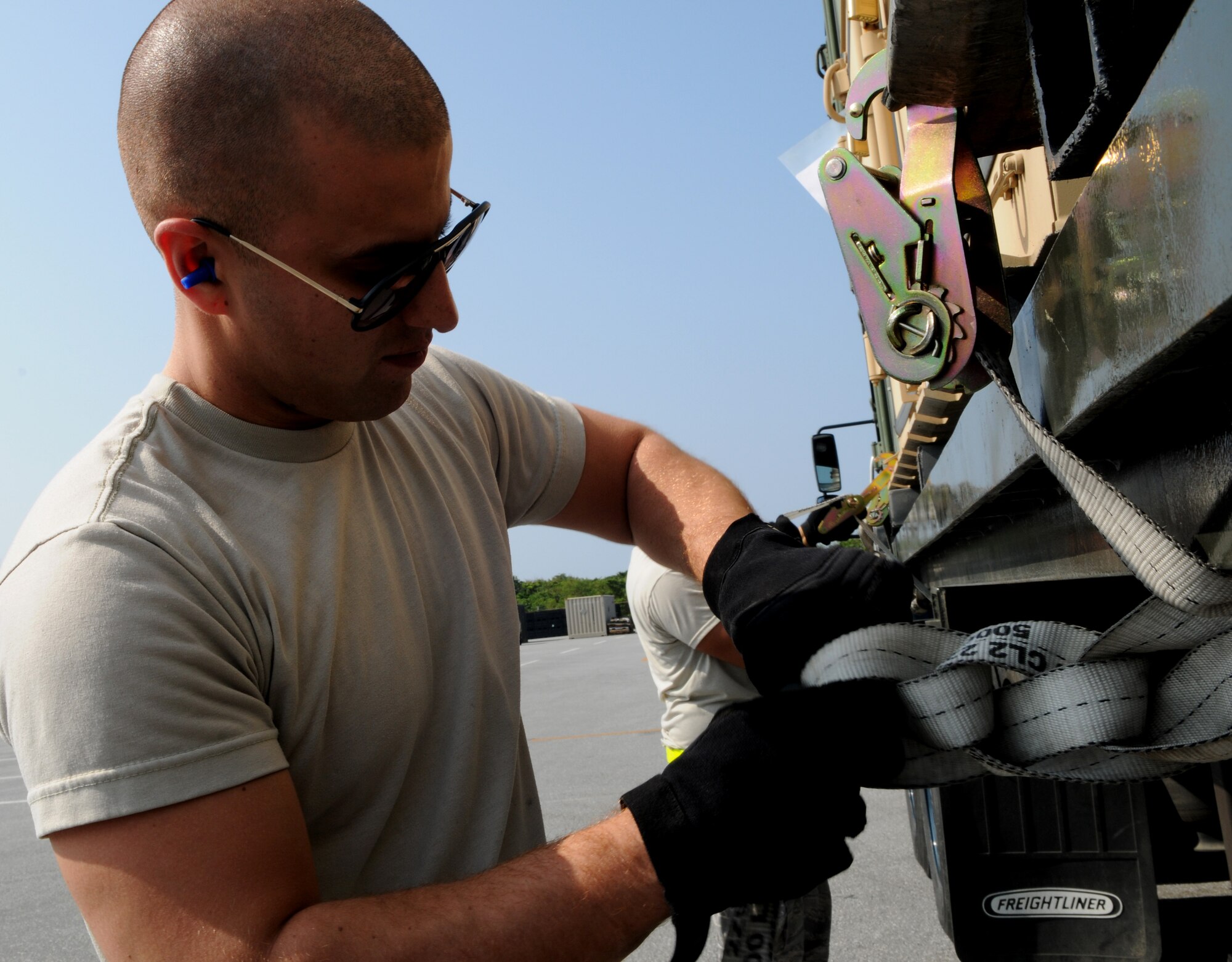 Airman 1st Class Jose Soto, a vehicle operator with the 18th Logistics Readiness Squadron, secures a cargo shipment in preparation for Balikatan at Kadena Air Base Feb. 24. Balikatan is an annual joint bilateral exercise between the U.S. military and the Philippine military designed to improve combined planning, combat readiness and interoperability for a wide range of operations. (U.S. Air Force photo/Airman 1st Class Jarvie Z. Wallace)