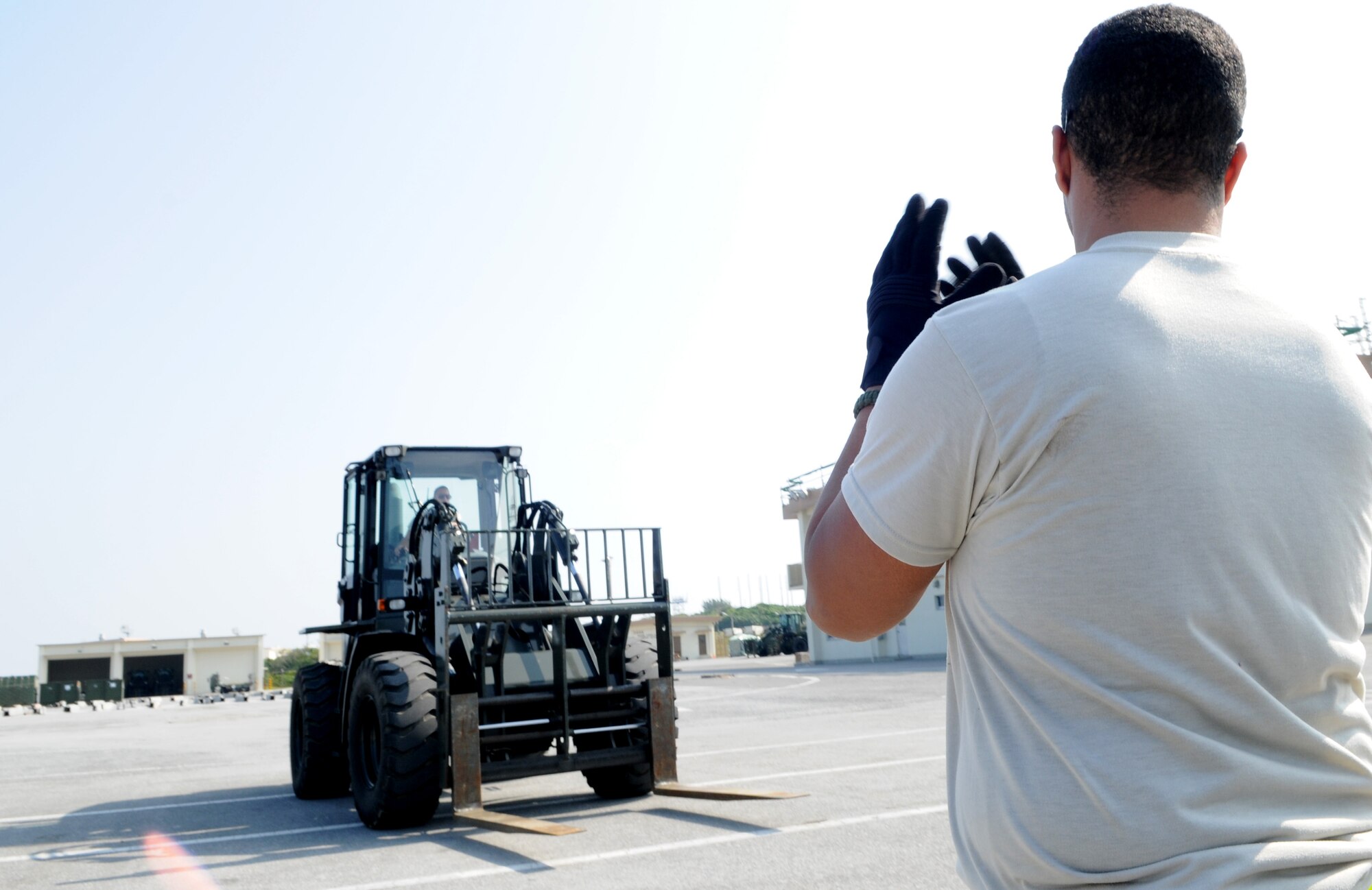 Airman 1st Class Steven Bradford, a vehicle operator with the 18th Logistics Readiness Squadron, directs a forklift in preparation for Balikatan at Kadena Air Base Feb. 24. Balikatan is an annual joint bilateral exercise between the U.S. military and the Philippine military designed to improve combined planning, combat readiness and interoperability for a wide range of operations. (U.S. Air Force photo/Airman 1st Class Jarvie Z. Wallace)