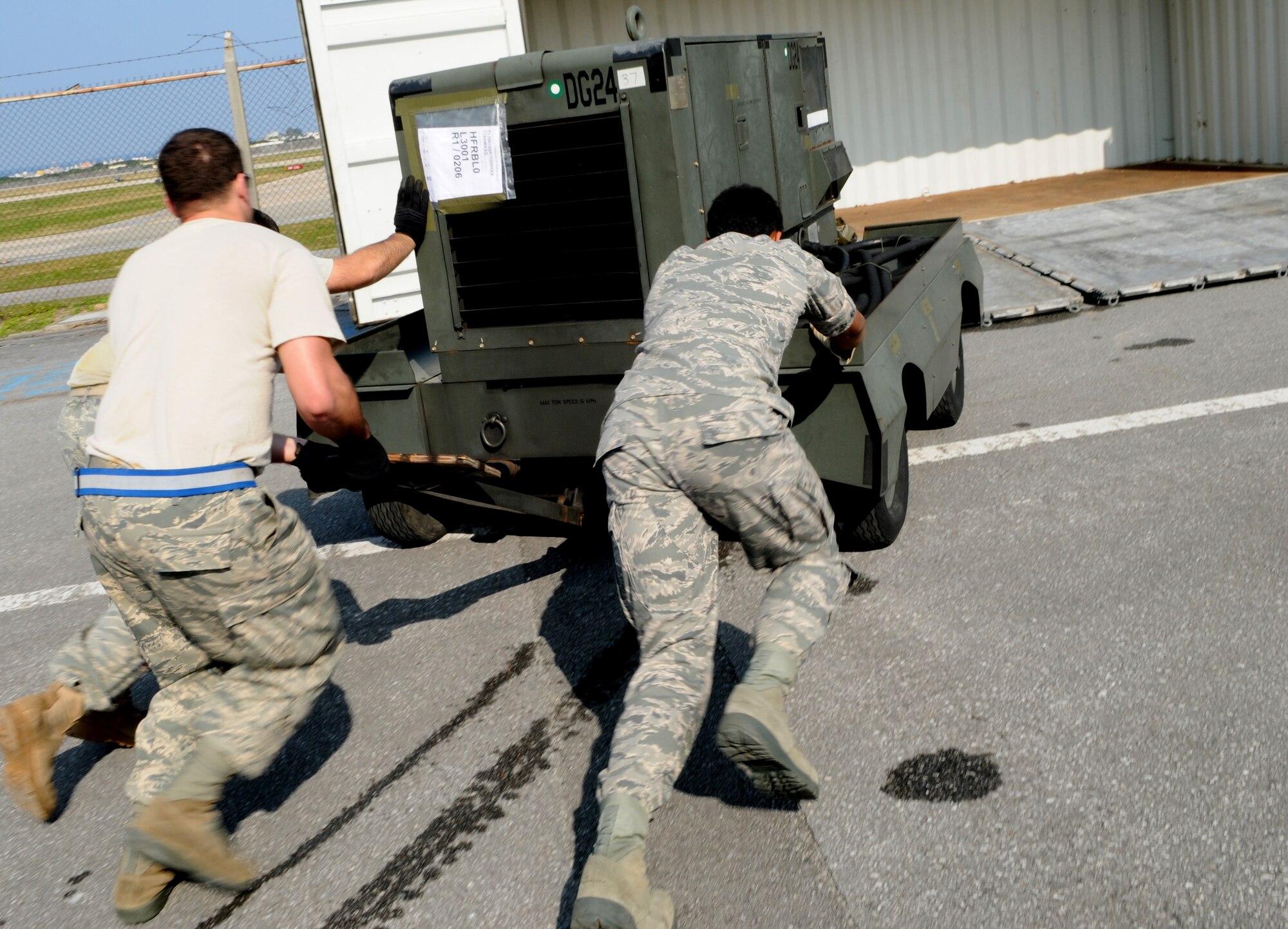 Airmen with the 18th Logistics Readiness Squadron move a self generating nitrogen cart into a shipment cargo in preparation for Balikatan at Kadena Air Base Feb. 24. Balikatan is an annual joint bilateral exercise between the U.S. military and the Philippine military designed to improve combined planning, combat readiness and interoperability for a wide range of operations. (U.S. Air Force photo/Airman 1st Class Jarvie Z. Wallace)