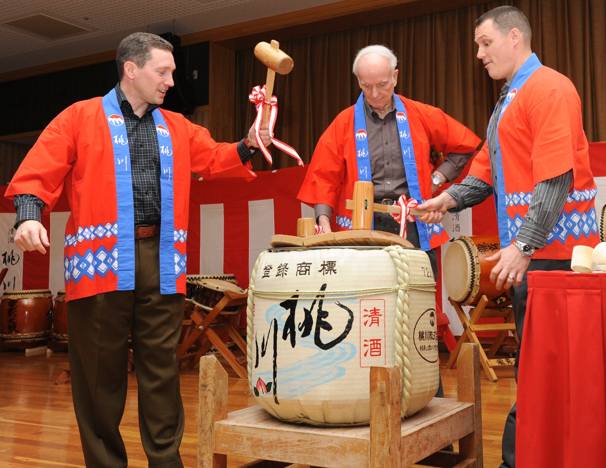 U.S. Air Force Col. Michael Rothstein, 35th Fighter Wing commander, left, Arthur J. Myers, Air Force Services director, center, and Maj. Thomas Esser, 35th Force Support Squadron commander, perform a traditional Japanese sake barrel breaking ceremony to kick off the John L. Hennessy Award evaluation Feb. 27, 2011, at Misawa Air Base, Japan. The John L. Hennessy Award is given to the best dining facility food service operation in the Air Force. (U.S. Air Force photo by Airman Basic James B. Bauer/Released)