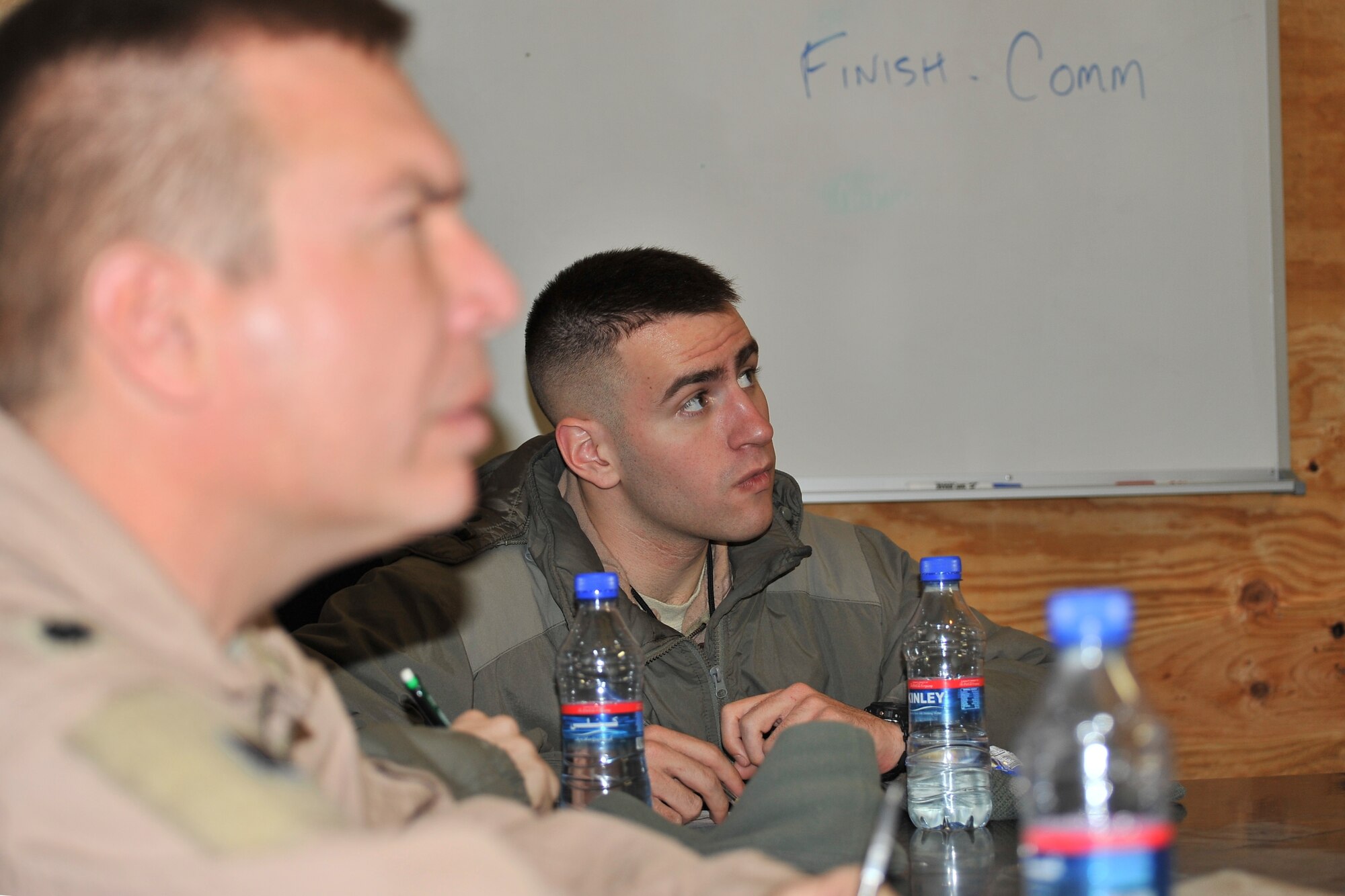 Aircrew members assigned to the 4th Expeditionary Reconnaissance Squadron take notes during a pre-flight mission brief.  The 4th ERS flies the MC-12 Liberty aircraft to provide intelligence, surveillance and reconnaissance support directly to ground forces.
