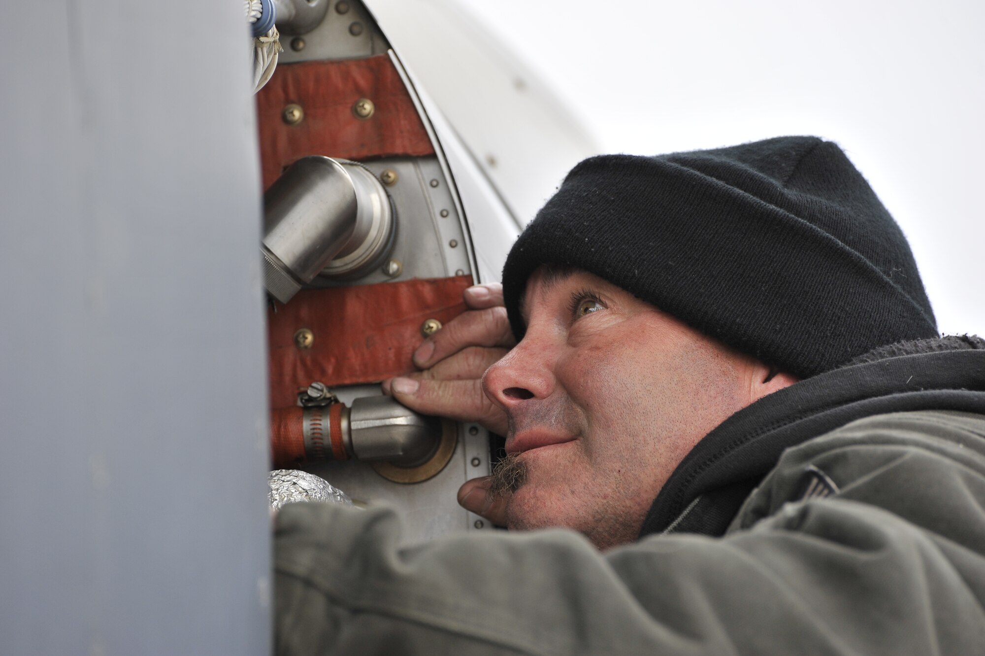 An MC-12 Liberty field service representative conducts a pre-flight maintenance check on an aircraft prior to take off from Bagram Airfield, Afghanistan.  The MC-12 is a joint forces air component commander asset in support of the joint force commander.