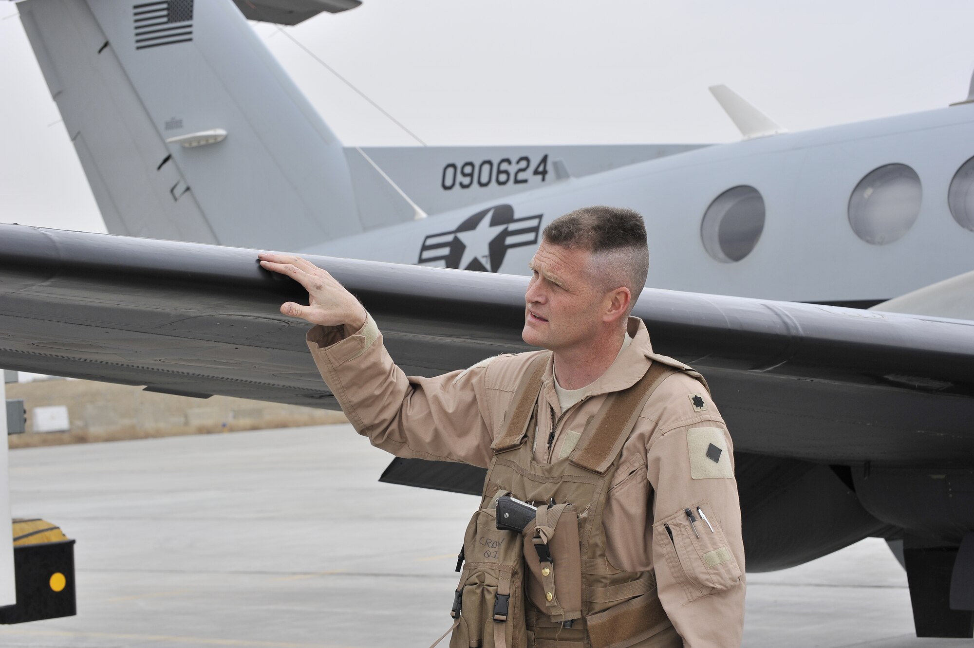 Lt. Col. James Thompson, 4th Expeditionary Reconnaissance Squadron commander, looks over his MC-12 Liberty prior to take off from Bagram Airfield, Afghanistan.  The MC-12 is not just an aircraft, but a complete collection, processing, analysis and dissemination system.