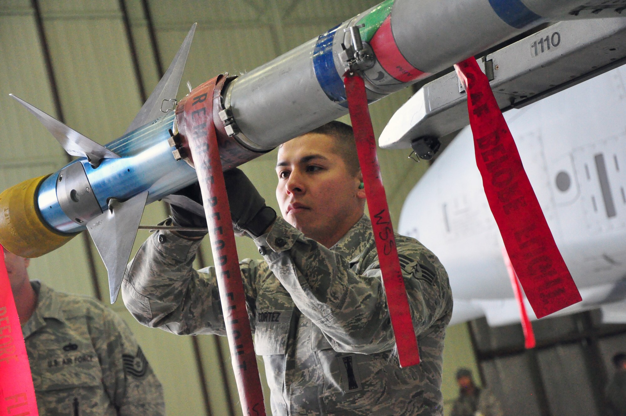 Senior Airman Jacob Cortez, 51st Aircraft Maintenance Squadron, performs some checks on an air-to-air missile during a weapons loading competition for the best load crew of the year in a hangar at Osan Air Base, Republic of Korea, Feb. 25 (U.S. Air Force photo/Staff Sgt. Chad Thompson).