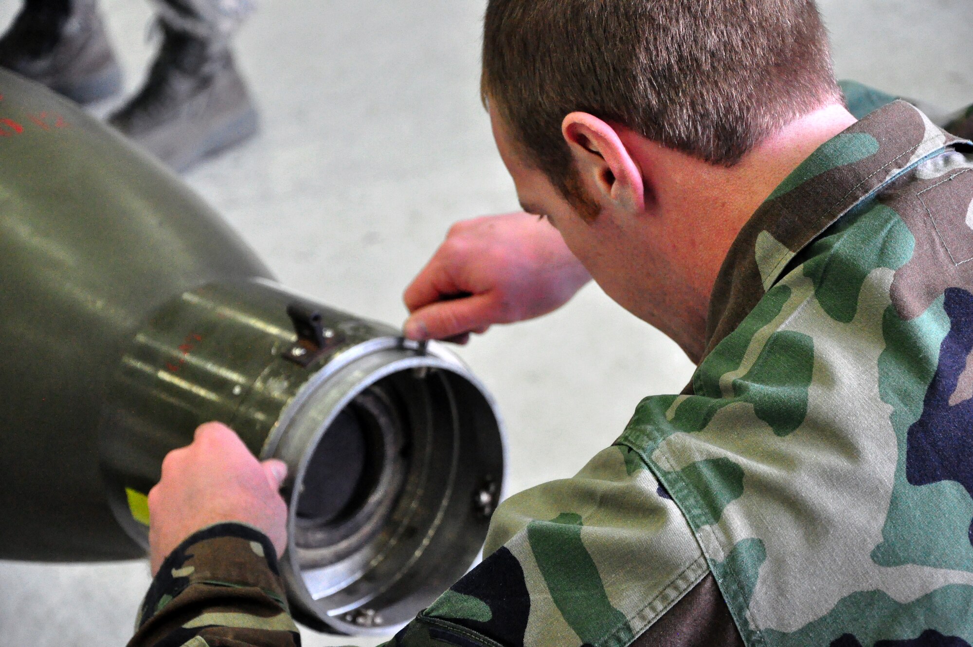 Senior Airman Joshua Gross, 51st Aircraft Maintenance Squadron, inspects an air-to-ground bomb during a weapons loading competition for the best load crew of the year in a hangar at Osan Air Base, Republic of Korea, Feb. 25 (U.S. Air Force photo/Staff Sgt. Chad Thompson).