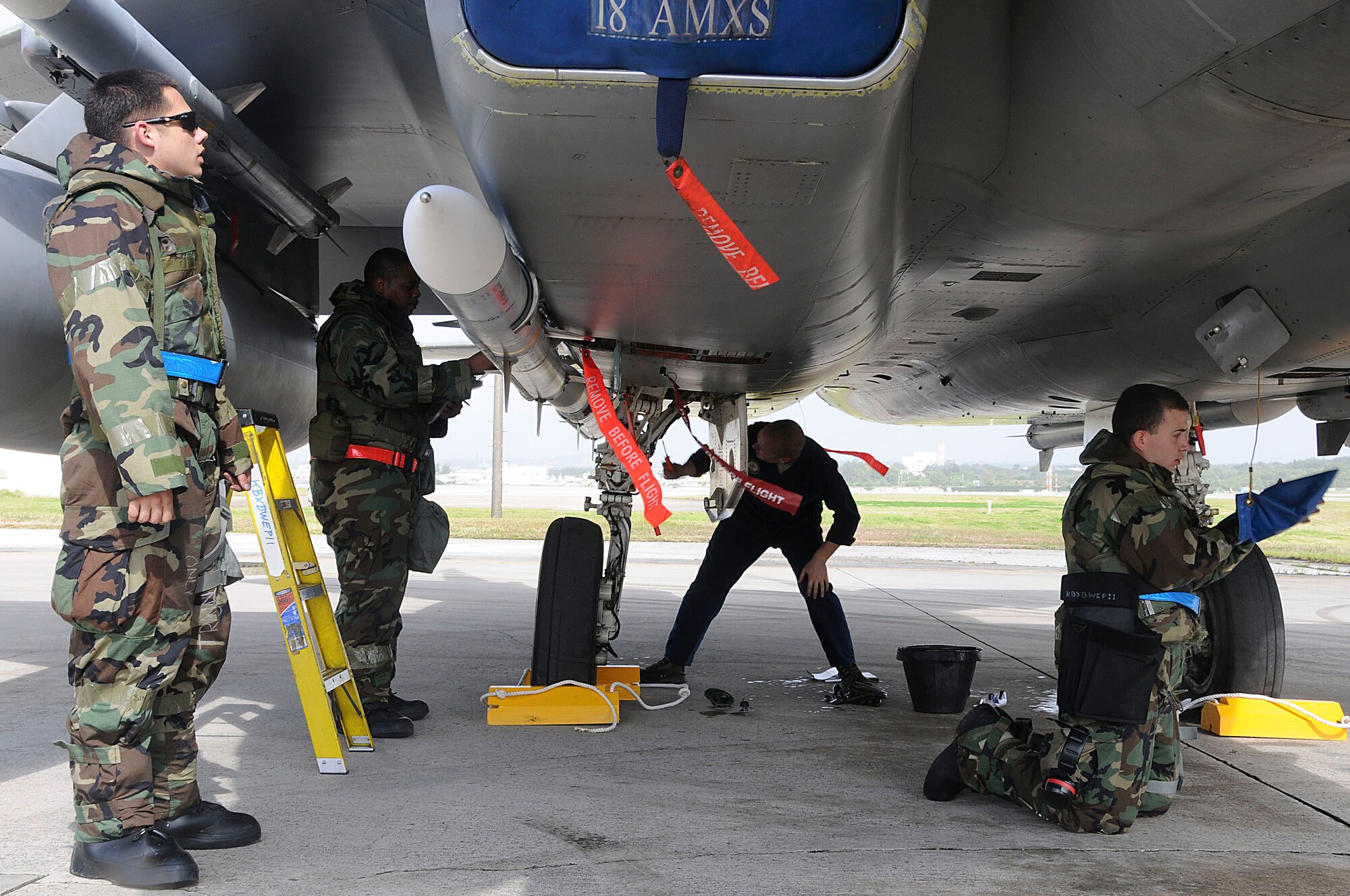 Crew chiefs from the 67th and 44th Aircraft Maintenance Units perform post-flight inspections of an F-15 Eagle during the Beverly High 11-03 exercise at Kadena Air Base, Feb 28. This post flight inspection ensures that the aircraft flew without any mishaps and that it's ready for potential flights. This local operational readiness exercise tests the 18th Wing members in various situations to ensure that all members know how to perform their job in contingency situations. (U.S. Air Force photo/Staff Sgt. Darnell T. Cannady)