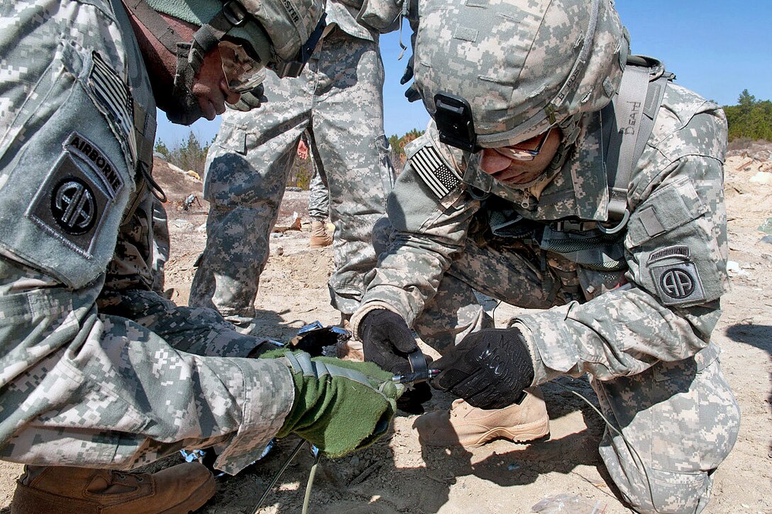 Army combat engineers attach a time fuse to a detonating-cord firing system so they can practice detonating a bomb remotely during training on Fort Bragg, N.C., Feb. 23, 2011.