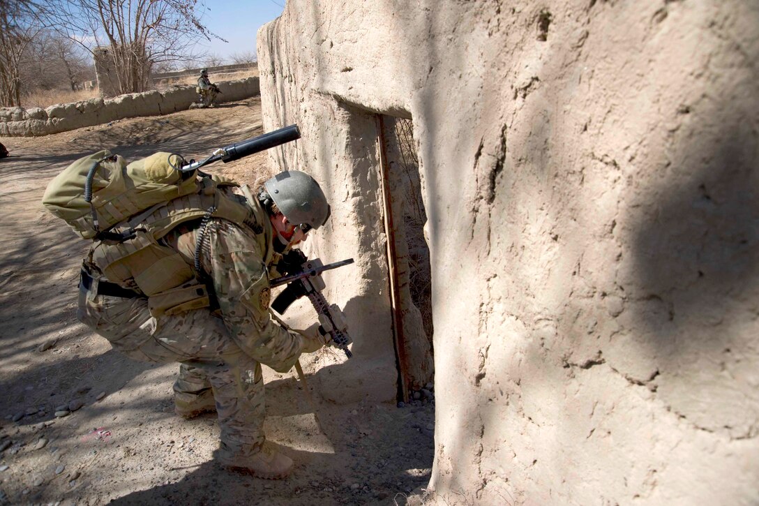 A U.S. Special Forces sergeant enters an abandoned compound in Kandahar province, Afghanistan, Feb. 20, 2011. Special Forces soldiers assigned to the Special Operations Task Force South regularly conduct patrols to secure abandoned buildings which may house explosive making material.
