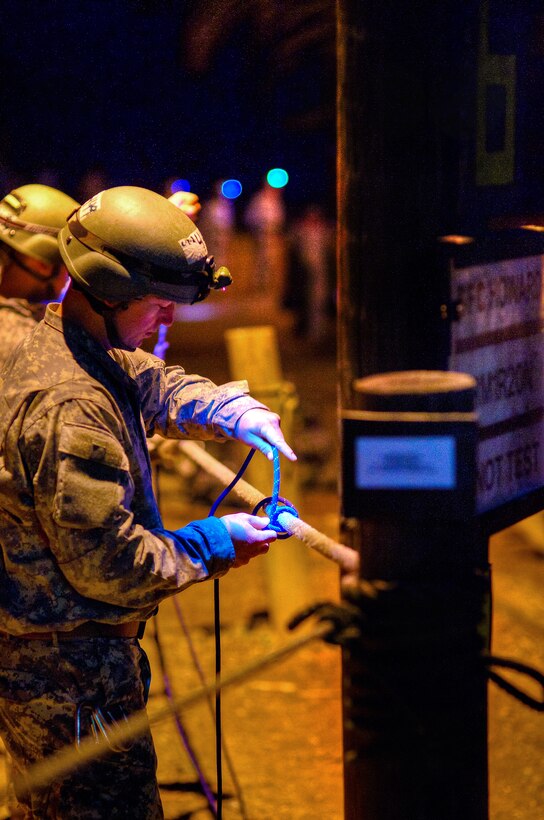 A U.S. Army Ranger ties a knot during a test early on day two of the Mountain Phase before the rope bridge training and vertical haul line exercises on Camp Merrill, Dahlonega, Ga., Feb. 21, 2011.