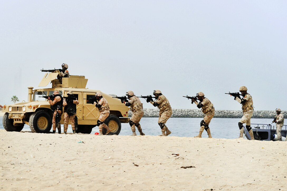 Kuwaiti marines secure the area during a beach assault exercise, which is part of a military demonstration held at the Marina Mall in Kuwait City, Feb. 28, 2011.