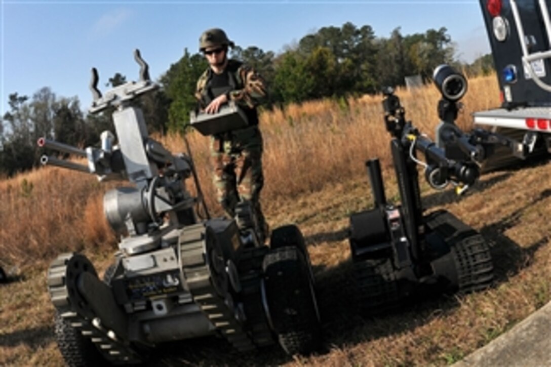 Chief Petty Officer Rich Mcave, assigned to Explosive Ordnance Disposal Mobile Unit 6, operates a Talon robot and a Remote Ordnance Neutralization System during an Exercise Solid Curtain-Citadel Shield 2011 vehicle borne improvised explosive device drill in Jacksonville, Fla., on Feb. 24, 2011.  The weeklong series of anti-terrorism and force protection exercises involves Navy installations and activities.  