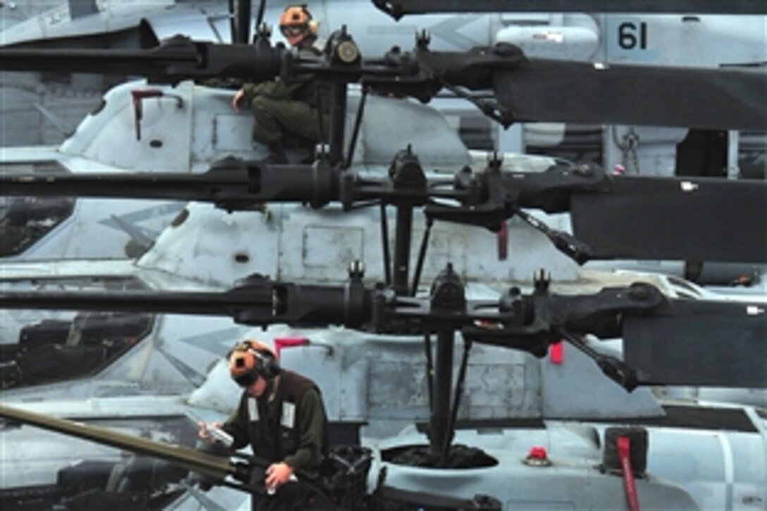 Marines conduct routine maintenance on helicopters aboard the amphibious assault ship USS Boxer, which is underway in the Pacific Ocean, Feb. 24, 2011. The Marines are assigned to the Marine Medium Squadron 163.