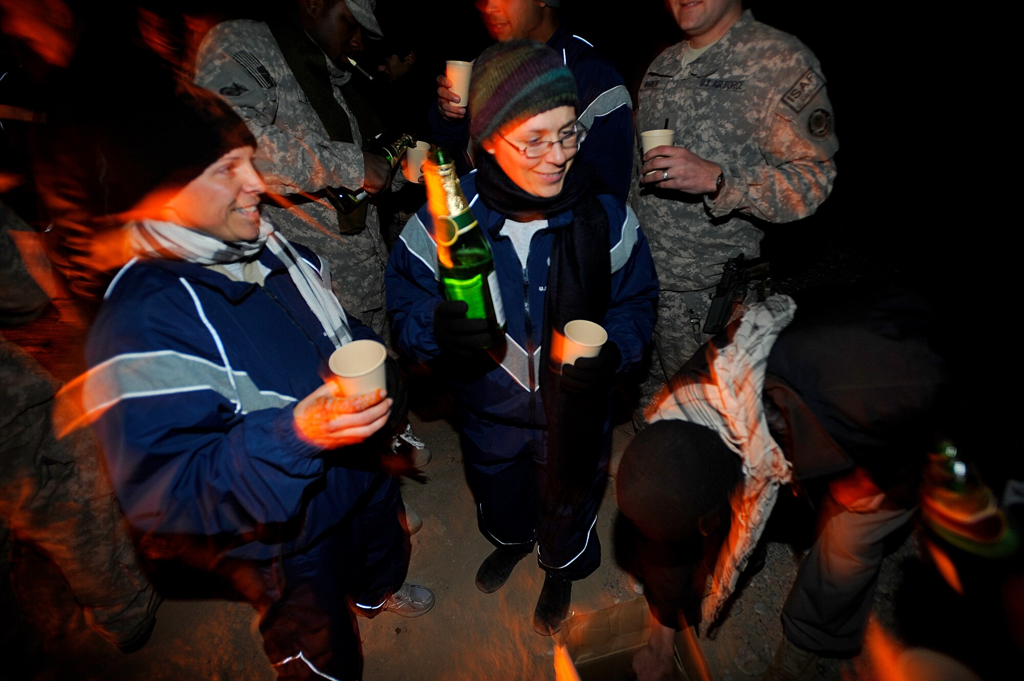 Capt. Dawn Russell (left) and Maj. Tracy Bozung enjoy a bottle of sparkling grape juice to celebrate New Year's Eve at Forward Operating Base Smart, Afghanistan. Capt. Russell and Maj. Bozung are assigned to Provincial Reconstruction Team Zabul.   (U.S. Air Force photo/Staff Sgt. Brian Ferguson)