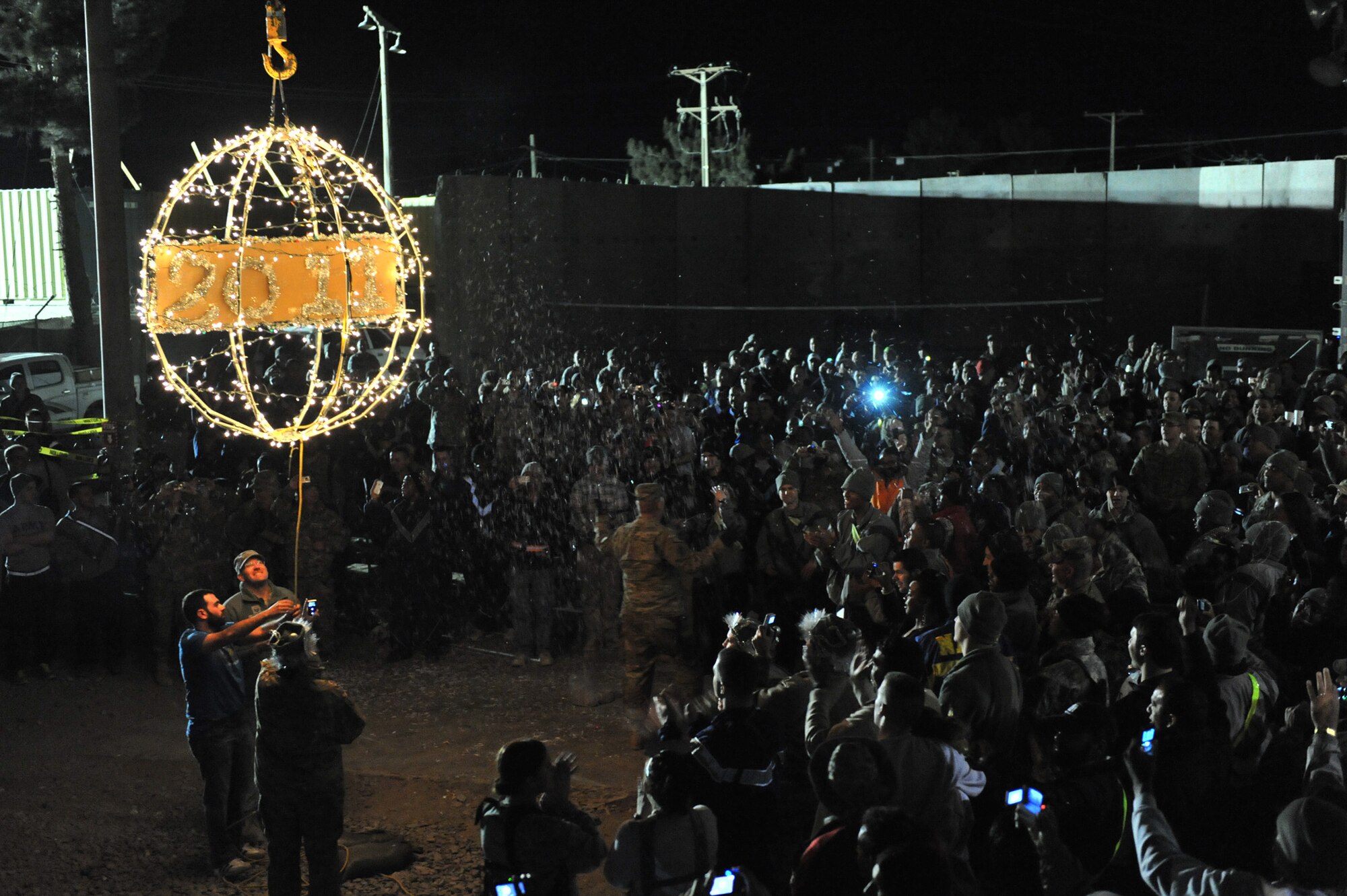 Airmen of the 455th Air Expeditionary Wing lower a symbolic 2011 ball at Bagram Airfield, Afghanistan. More than 700 airmen attended the celebration brining in the New Year. Festivities included Bagram Idol singing competition, music and prizes. The 2011 ball was designed and constructed by Tech. Sgt. Kevin Enright, 455th Expeditionary Civil Engineer Squadron electrician. (Air Force photo/Senior Airman Sheila deVera) 