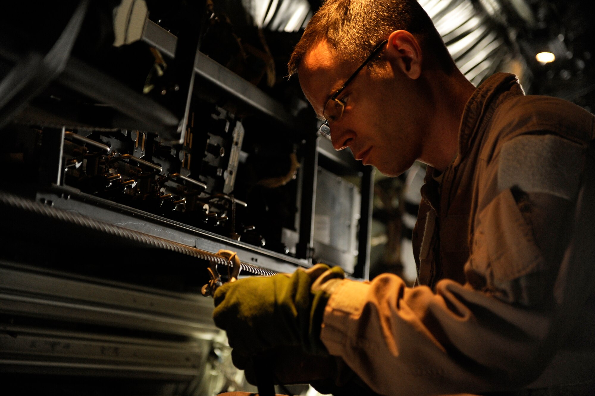 U.S. Air Force Tech. Sgt. Brian Digsby, 772nd Expeditionary Airlift Squadron, connects a parachute to a static line aboard a C-130J Hercules before a mission in support of Operation Enduring Freedom at Kandahar Airfield, Afghanistan, Dec. 29. C-130 aircrews ensure that troops on the ground have adequate supplies to complete their mission. (U.S. Air Force Photo/Staff Sgt. Eric Harris) 
