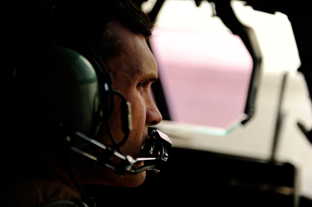 U.S. Air Force Capt. Jeff Brown, 772nd Expeditionary Airlift Squadron, watches a taxiway while waiting for clearance to move aboard a C-130J Hercules before an air drop mission in support of Operation Enduring Freedom at Kandahar Airfield, Afghanistan, Dec. 29. C-130 aircrews ensure that troops on the ground have adequate supplies to complete their mission by air dropping their supplies. (U.S. Air Force Photo/Staff Sgt. Eric Harris) 