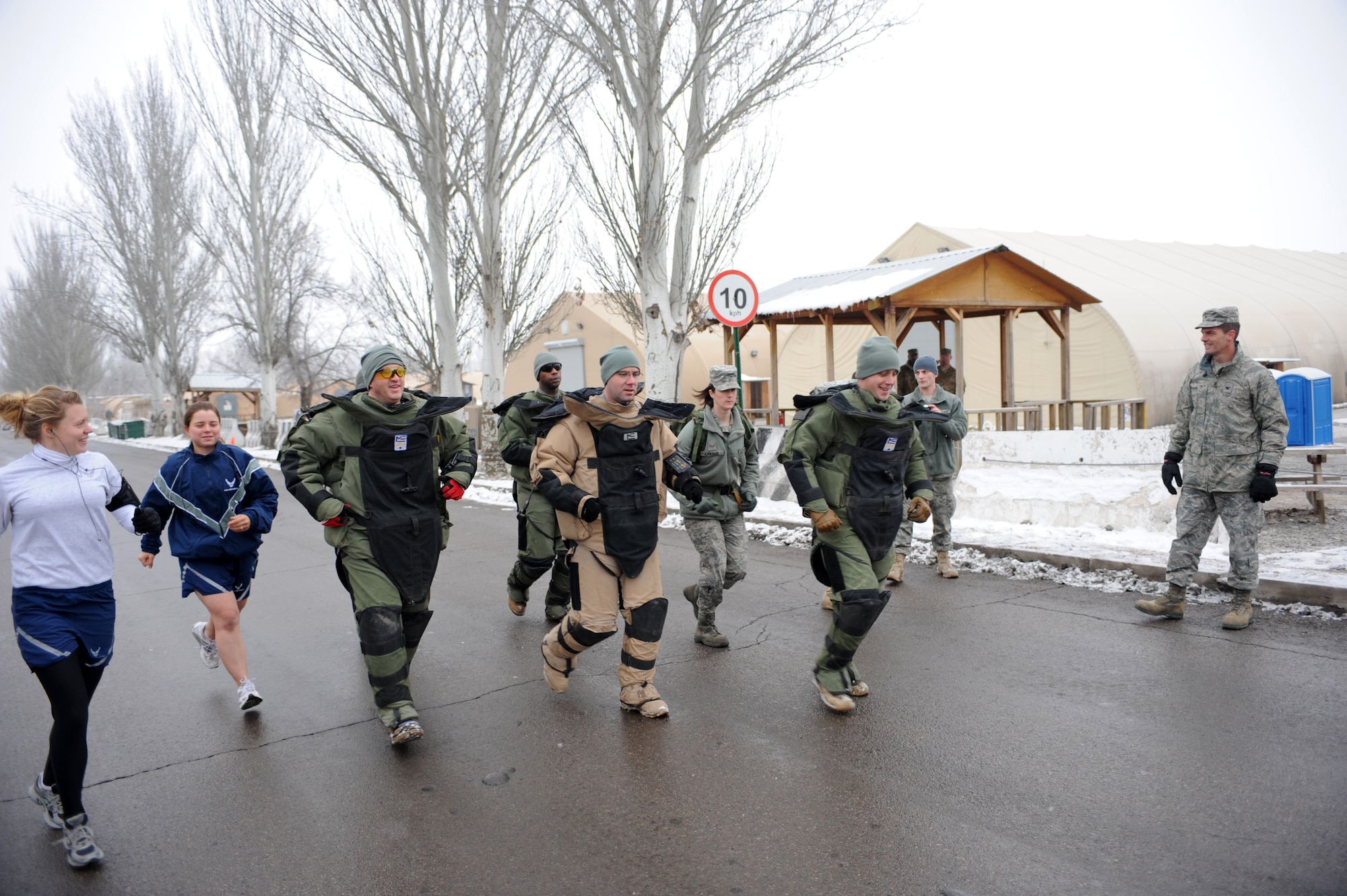 TRANSIT CENTER AT MANAS, Kyrgyzstan - TCM Explosive Ordinance Technicians in 85 lb bomb suits and their supporters are off and running in a 5 km race here Dec 31. The purpose of the 5K Bomb Suit Run is to raise funds and awareness for the EOD Memorial and Wounded EOD Warrior Foundations. (U.S. Air Force photo/Tech. Sgt. Jerome Baysmore)