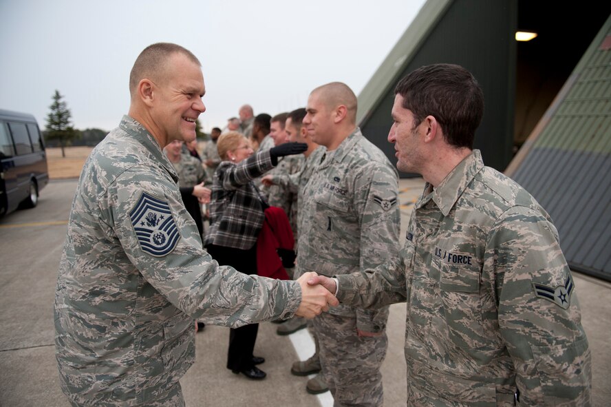 Chief Master Sgt. of the Air Force James Roy shakes hands with Airman 1st Class Devin Pellerin, 35th Aircraft Maintenance Squadron precision guided munitions crewmember, during a visit to the flightline Dec. 28, 2010, at Misawa Air Base, Japan. Chief Roy visited a hardened aircraft shelter to meet the Airmen who keep the 35th Fighter Wing's F-16 Fighting Falcons flying. (U.S. Air Force photo by Staff Sgt. Samuel Morse/Released)