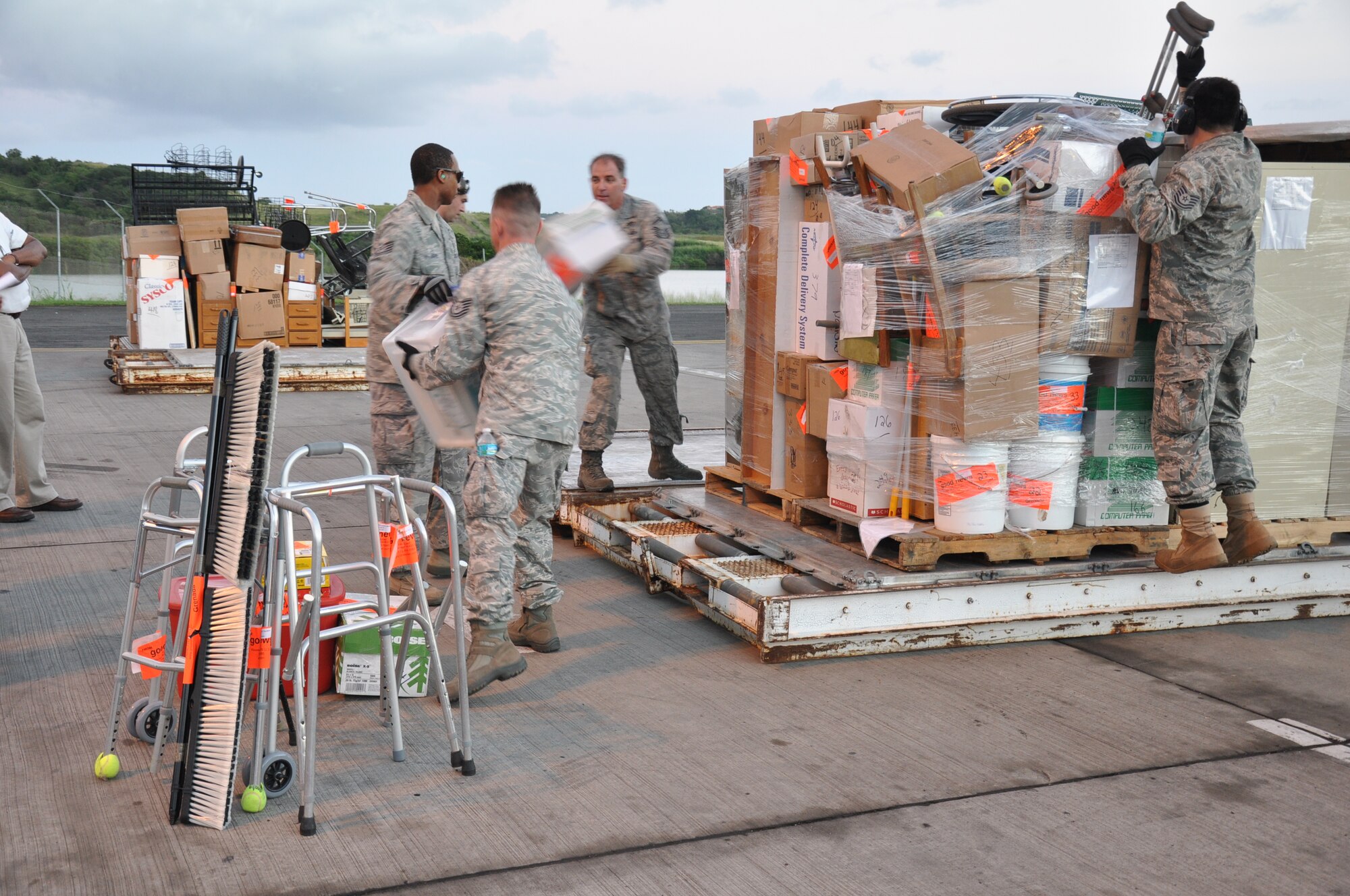 Aerial porters from the 81st Aerial Port Squadron, Joint Base Charleston, S.C., sort donated items delivered to the people of Grenada and prepare them for delivery during a humanitarian aid mission to Haiti and Grenada Dec. 30, 2010. (U.S. Air Force photo/Senior Airman Robert Pilch)