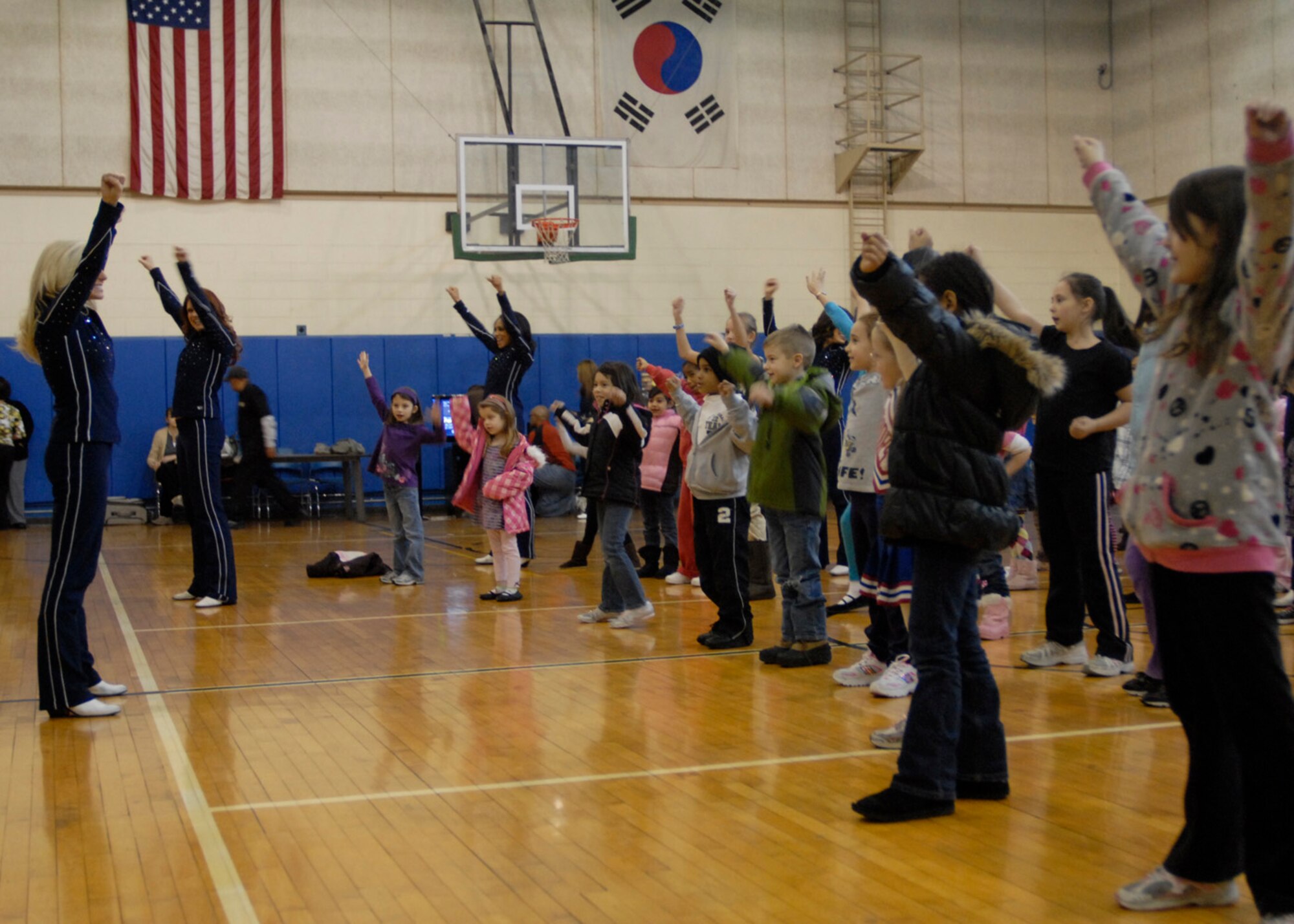 Dallas Cowboys Cheerleaders participate in a free cheer clinic for Team Osan family members at the Youth Center during a base visit Dec. 29. (U.S. Air Force photo/1st Lt. Cody Chiles)