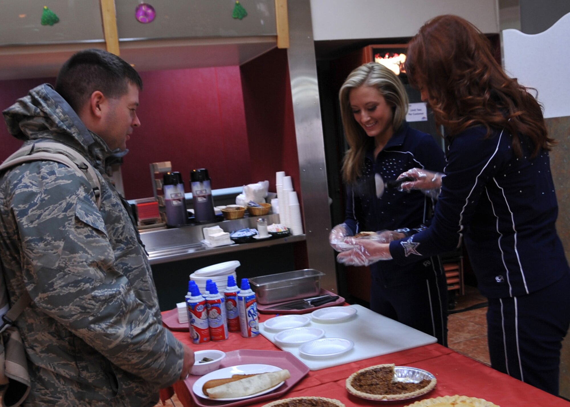 Dallas Cowboys Cheerleaders serve dessert to Airmen at Osan’s Gingko Tree dining facility during a base visit Dec. 29. (U.S. Air Force photo/Senior Airman Evelyn Chavez)