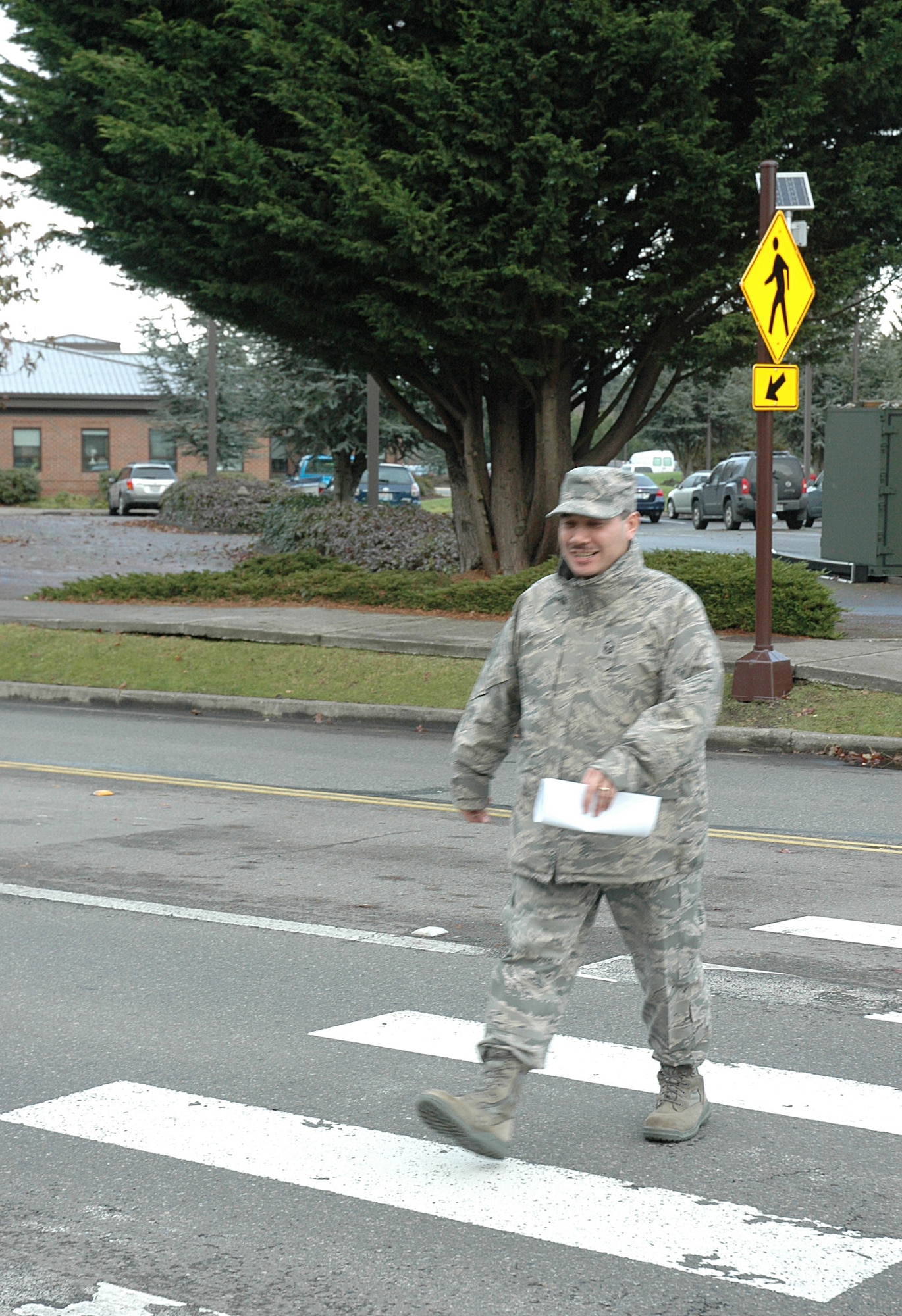 MCCHORD FIELD, Wash., - Master Sgt. Lyle Harvey, 446th Force Support Squadron, crosses the street between Bldg. 1214 and Bldg. 1205, where a new flashing signal marks the crosswalk. (U.S. Air Force photo/Sandra Pishner)