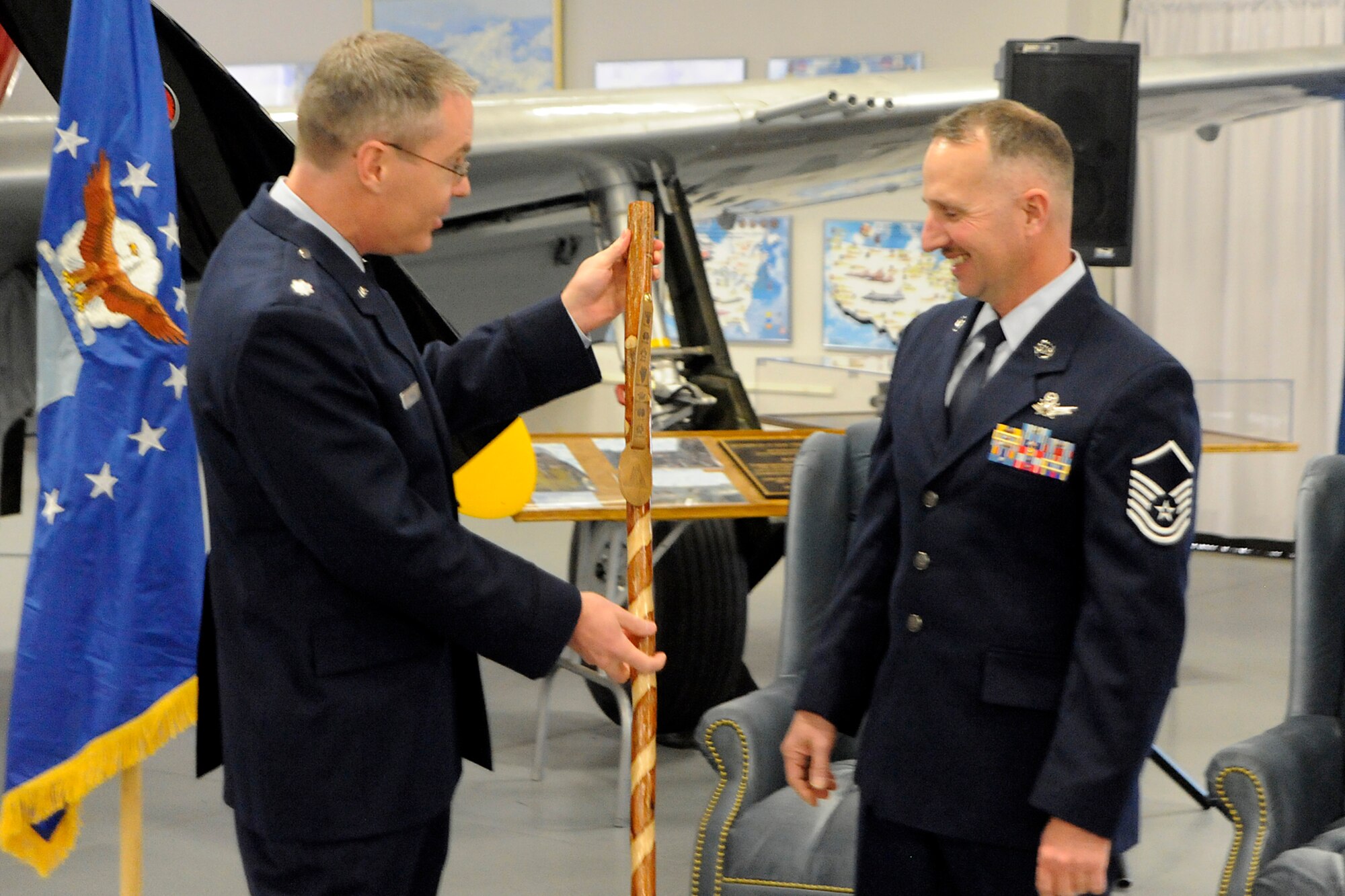 Lt. Col. Aaron Bass, 21st Operations Group standardization and evaluation chief, presents Master Sgt. Micheal Meyer, 21st OG noncommissioned officer in charge of standardization, with the “Old Man of Space Staff” Dec. 8, at the Peterson Air and Space Museum on Peterson Air Force Base during Sergeant Meyer’s retirement ceremony. Sergeant Meyer, who officially retires April 1, 2011, is the longest serving space operator in Air Force Space Command. He joined the Air Force in 1986 when space operator was a new career field for enlisted troops. (U.S. Air Force photo/Dennis Howk)
