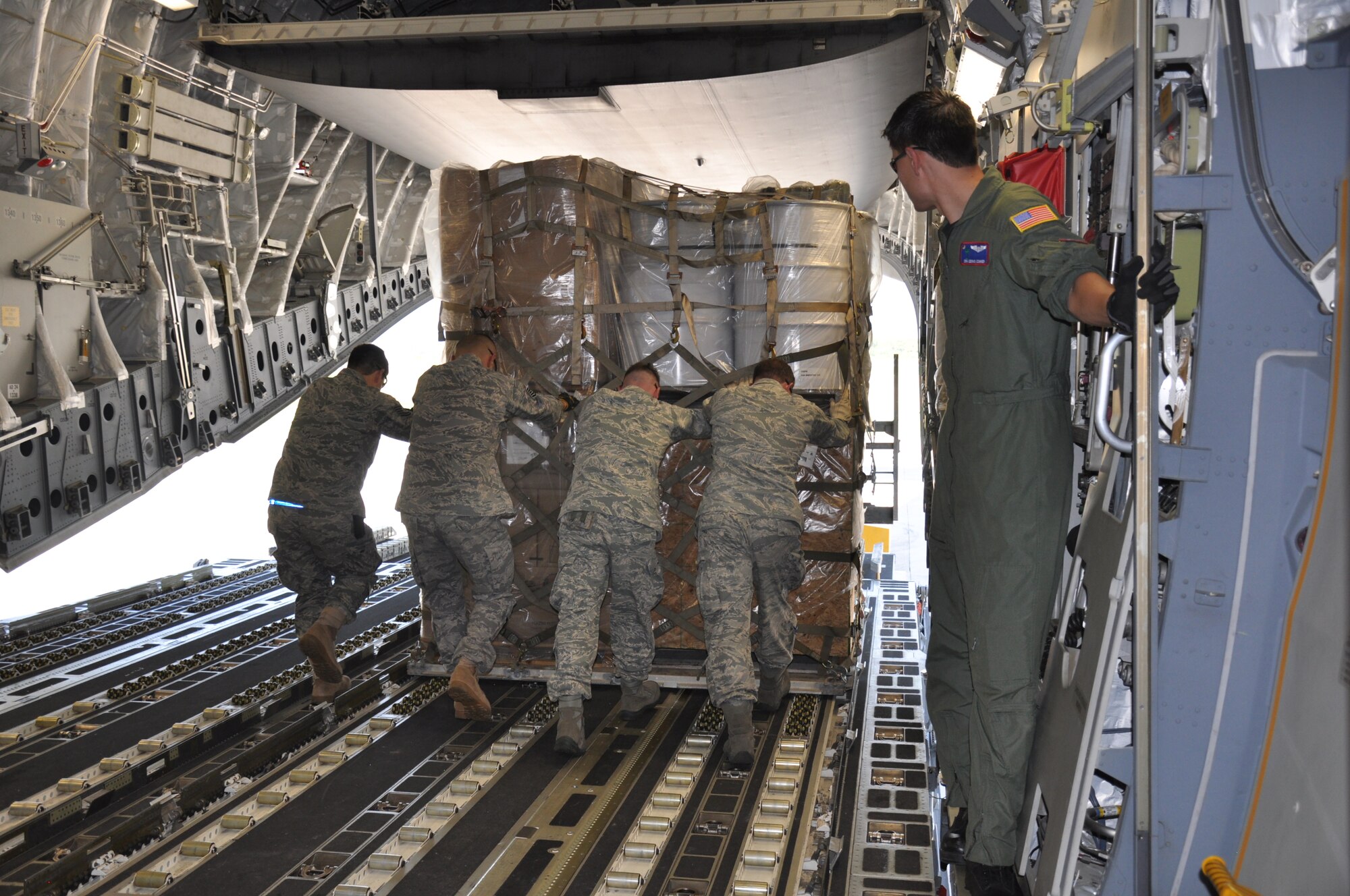 Members from the 81st Aerial Port Squadron, Joint Base Charleston, S.C. offload aid from a C-17 Globemaster III aircraft during a humanitarian aid mission to Haiti and Grenada Dec. 30, 2010. (U.S. Air Force photo/Senior Airman Robert Pilch)