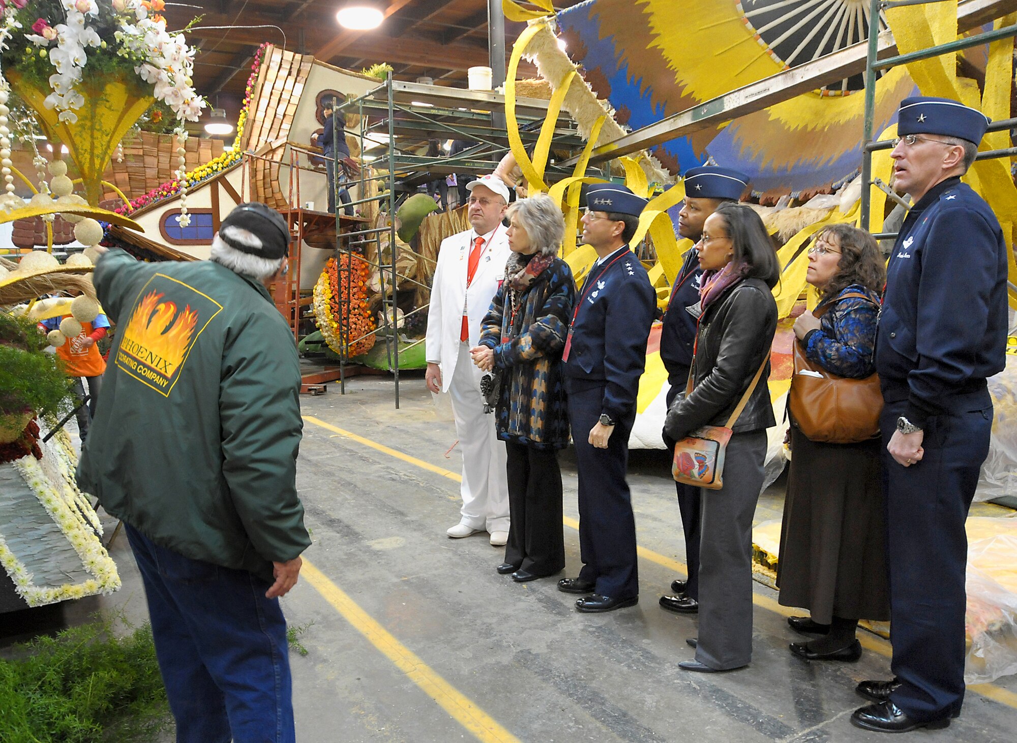 (From left to right) Mr. Paul Sherrod, Tournament of Roses tour guide, explains the intricacies of float decoration to Mr. Gary Leonard, TOR host, Mrs. and Lt. Gen. Tom Sheridan, Brig. Gen. and Mrs. Sam Greaves, and Mrs. and Brig. Gen. Scott Vander Hamm, while the group visits the TOR's Decorating Places Dec. 31, 2010. (Photo by Joe Juarez)