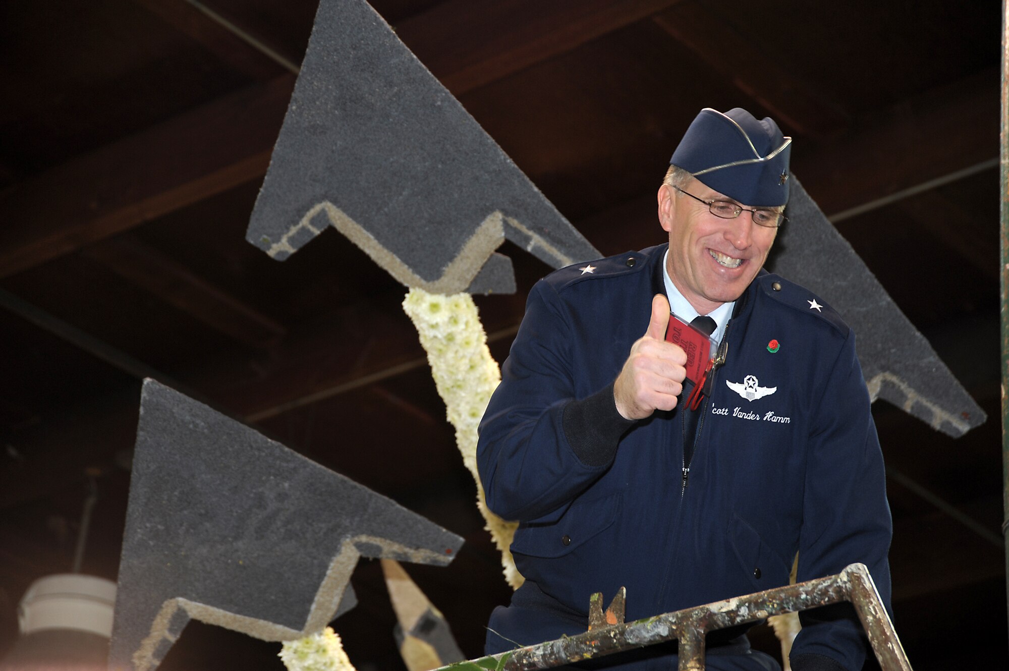 Brig. Gen. Scott Vander Hamm, Commander of the 509th Bomber Wing, Whiteman Air Force Base, Mo., poses for a photo on a float that features Air Force aircraft such as F-117, F-22 and B-2 while visiting the Tournament of Roses' Decorating Places Dec. 31, 2010. A B-2 from the 509 BW performed the flyover over this year's 122nd annual parade. (Photo by Joe Juarez)