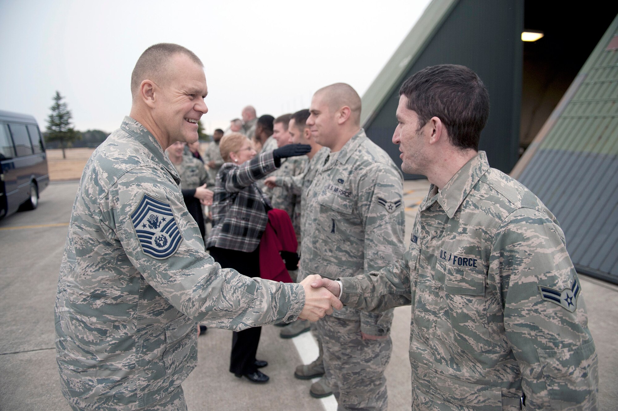 Chief Master Sgt. of the Air Force James A. Roy shakes hands with Airman 1st Class Devin Pellerin Dec. 28, 2010, during a visit to the flightline at Misawa Air Base, Japan. Chief Roy visited a hardened aircraft shelter to meet the maintainers of the 35th Fighter Wing. Airman Pellerin is a 35th Aircraft Maintenance Squadron precision guided munitions crewmember. (U.S. Air Force photo/Staff Sgt. Samuel Morse)