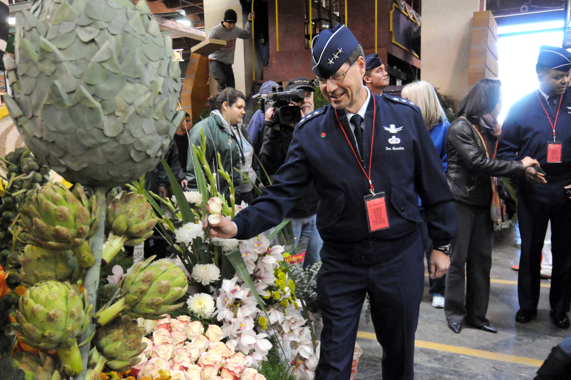 Lt. Gen. Tom Sheridan, Commander of the Space and Missile Systems Center, Los Angeles Air Force Base, places a rose on a parade float while visiting the Tournament of Roses' Decorating Places Dec. 31, 2010. (Photo by Joe Juarez)