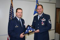 Lt. Col. James Clutter, 916th Civil Engineer Flight commander, presents Master Sgt. Dean Galligan with his retirement certificate. (USAF photo courtesy of 916 CEF)