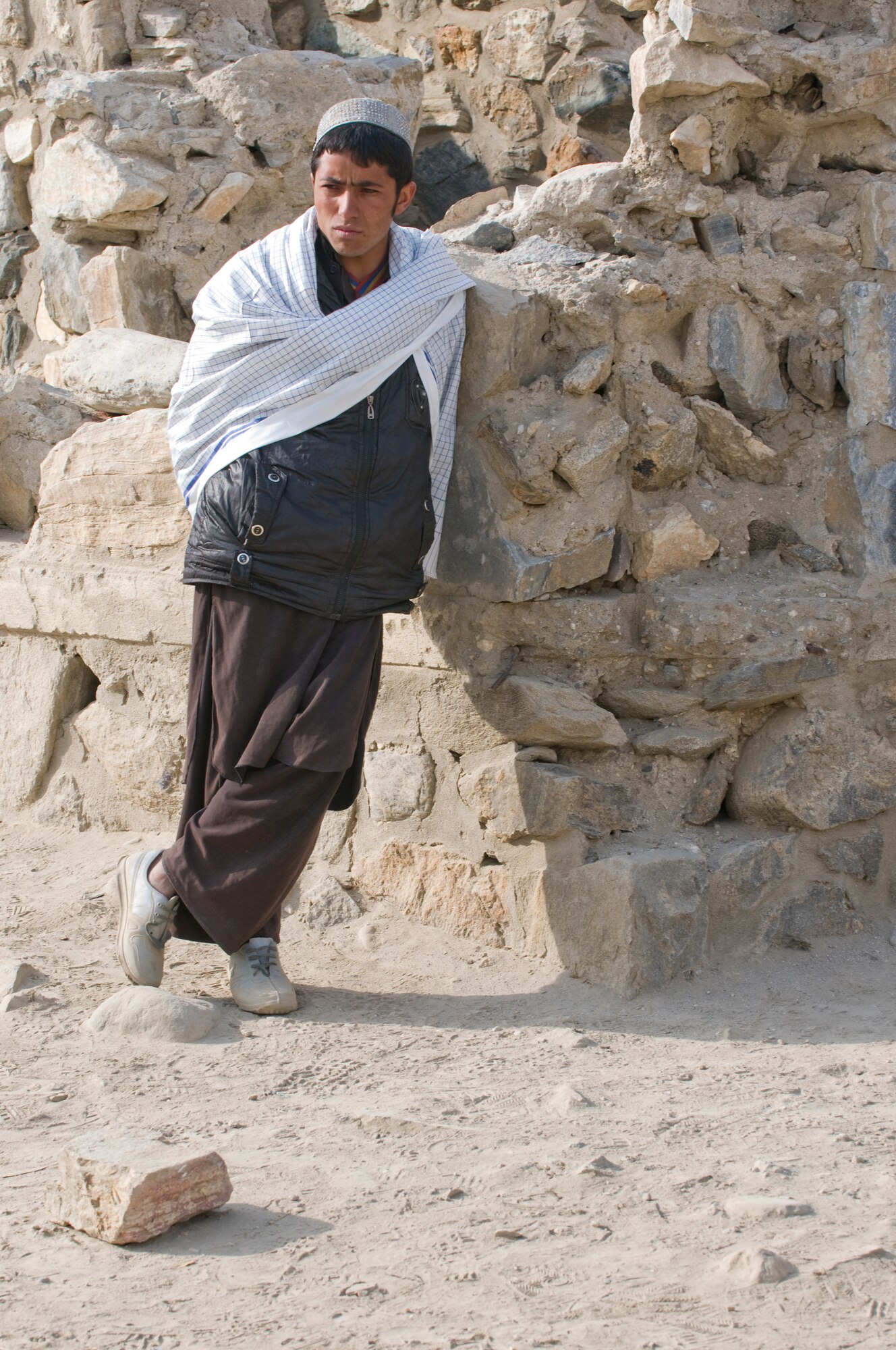 KAPISA PROVINCE, Afghanistan – A local child leans on part of the remains of an old school during a site survey for the proposed Abdul Hadi Padar secondary school in the Nijrab valley. This site survey was conducted with Kapisa provincial development council representatives, Kapisa Ministry of Education engineers, and local village elders and shura members to ensure everyone’s input was taken into consideration. By working together, the group is able to collectively identify the most suitable locations for proposed projects. The mission of Kapisa PRT is to help facilitate the local and national governments of Afghanistan working together to help provide for the development and security needs of the Afghan people.  (Photo by U.S. Air Force Staff Sgt. Kyle Brasier, Kapisa Provincial Reconstruction Team / released) 

