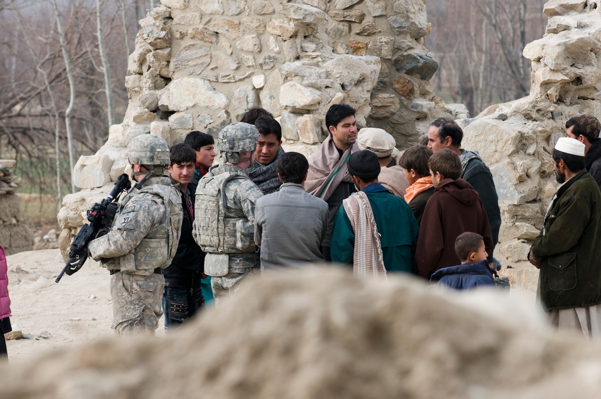 KAPISA PROVINCE, Afghanistan – U.S. Air Force Capt. Seth Platt, Kapisa Provincial Reconstruction Team civil engineer from Pomfret, Conn., meets with locals during a site survey for the proposed Abdul Hadi Padar secondary school in the Nijrab valley. This site survey was conducted with Kapisa provincial development council representatives, Kapisa Ministry of Education engineers, and local village elders and shura members to ensure everyone’s input was taken into consideration. By working together, the group is able to collectively identify the most suitable locations for proposed projects. The mission of Kapisa PRT is to help facilitate the local and national governments of Afghanistan working together to help provide for the development and security needs of the Afghan people.  (Photo by U.S. Air Force Staff Sgt. Kyle Brasier, Kapisa Provincial Reconstruction Team / released) 