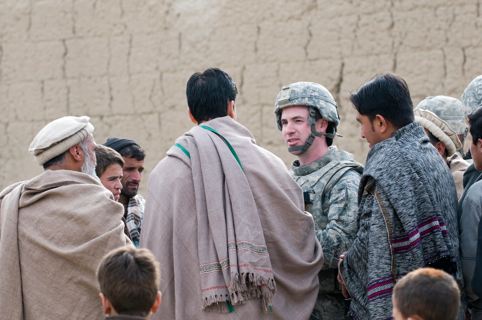 KAPISA PROVINCE, Afghanistan – U.S. Air Force Capt. Seth Platt, Kapisa Provincial Reconstruction Team civil engineer from Pomfret, Conn., meets with locals during a site survey for the proposed Abdul Hadi Padar secondary school in the Nijrab valley. This site survey was conducted with Kapisa provincial development council representatives, Kapisa Ministry of Education engineers, and local village elders and shura members to ensure everyone’s input was taken into consideration. By working together, the group is able to collectively identify the most suitable locations for proposed projects. The mission of Kapisa PRT is to help facilitate the local and national governments of Afghanistan working together to help provide for the development and security needs of the Afghan people.  (Photo by U.S. Air Force Staff Sgt. Kyle Brasier, Kapisa Provincial Reconstruction Team / released) 