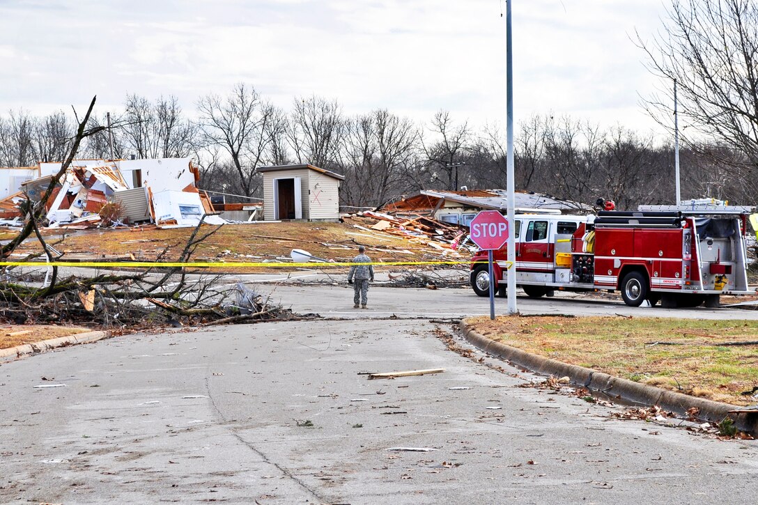 A U.S. Army soldier conducts a traffic control point as local emergency responders assess damage to military housing following a tornado touchdown on Fort Leonard Wood, Mo., Dec. 31, 2010.