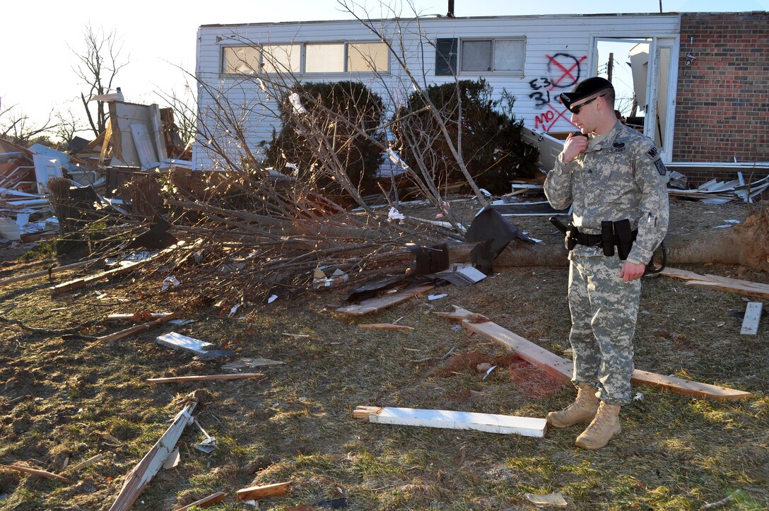 U.S. Army Sgt. Andrew Dean reports the status of a damaged military housing structure, Jan. 2, 2011, after a tornado touchdown on Fort Leonard Wood, Mo., Dec. 31, 2010. Dean, a military policeman assigned to the 463rd Military Police Company, 4th Maneuver Enhancement Brigade, was one of the first responders after a New Year's Eve tornado struck the post.