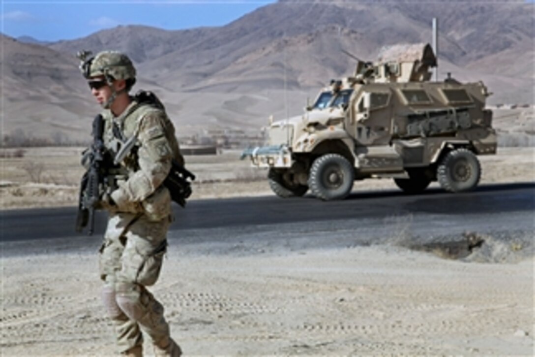 U.S. Army Pfc. Samuel Ford walks next to his vehicle in order to clear and document culverts along a highway in the Wardak province, Afghanistan, on Dec. 21, 2010.  Ford is assigned to the 10th Mountain Division's Company B, 2nd Battalion, 4th Infantry Regiment, 4th Brigade Combat Team.  