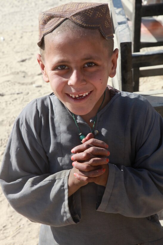 An Afghan boy waits to receive food and other supplies during a humanitarian aid event in Sangin, Helmand province, Afghanistan, Jan. 3, 2011. U.S. Marines assigned to 3rd Battalion, 5th Marines, Regimental Combat Team 2 conducted humanitarian aid and counterinsurgency operations in support of the International Security Assistance Force in order to gain the support of the Afghan residents and decrease insurgent activity.