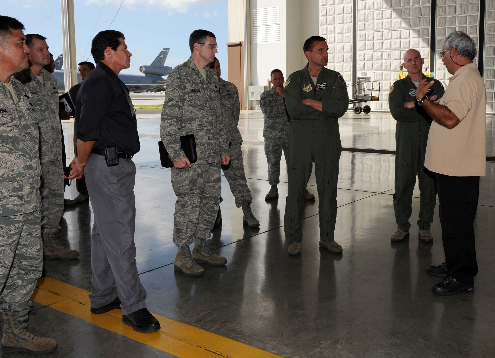 Lt. Gen. Ted Kresge (center in flightsuit), 13th Air Force commander, is briefed on aspects of the 15th Maintenance Group inside Hangar 21 at the 15th Wing Jan. 4. General Kresge met with Airmen and learned the mission and functions of various units here during his visit to the wing. (U.S. Air Force photo/Airman 1st Class Lauren Main)
