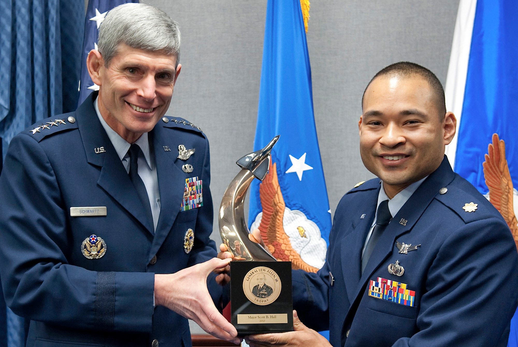 Air Force Chief of Staff Gen. Norton Schwartz presents the 2010 General Lew Allen Jr. Award to Maj. Scott Hall during a ceremony Jan. 4, 2011, in the Pentagon. The award is presented annually to an officer and to an NCO working in aircraft, munitions or missile maintenance and directly involved in aircraft sortie generation. The award's namesake served as the Air Force Chief of Staff from 1978 to 1982. Major Hall was honored for his work as the 20th Aircraft Maintenance Squadron maintenance operations officer at Shaw Air Force Base, S.C. (U.S. Air Force photo/Jim Varhegyi)