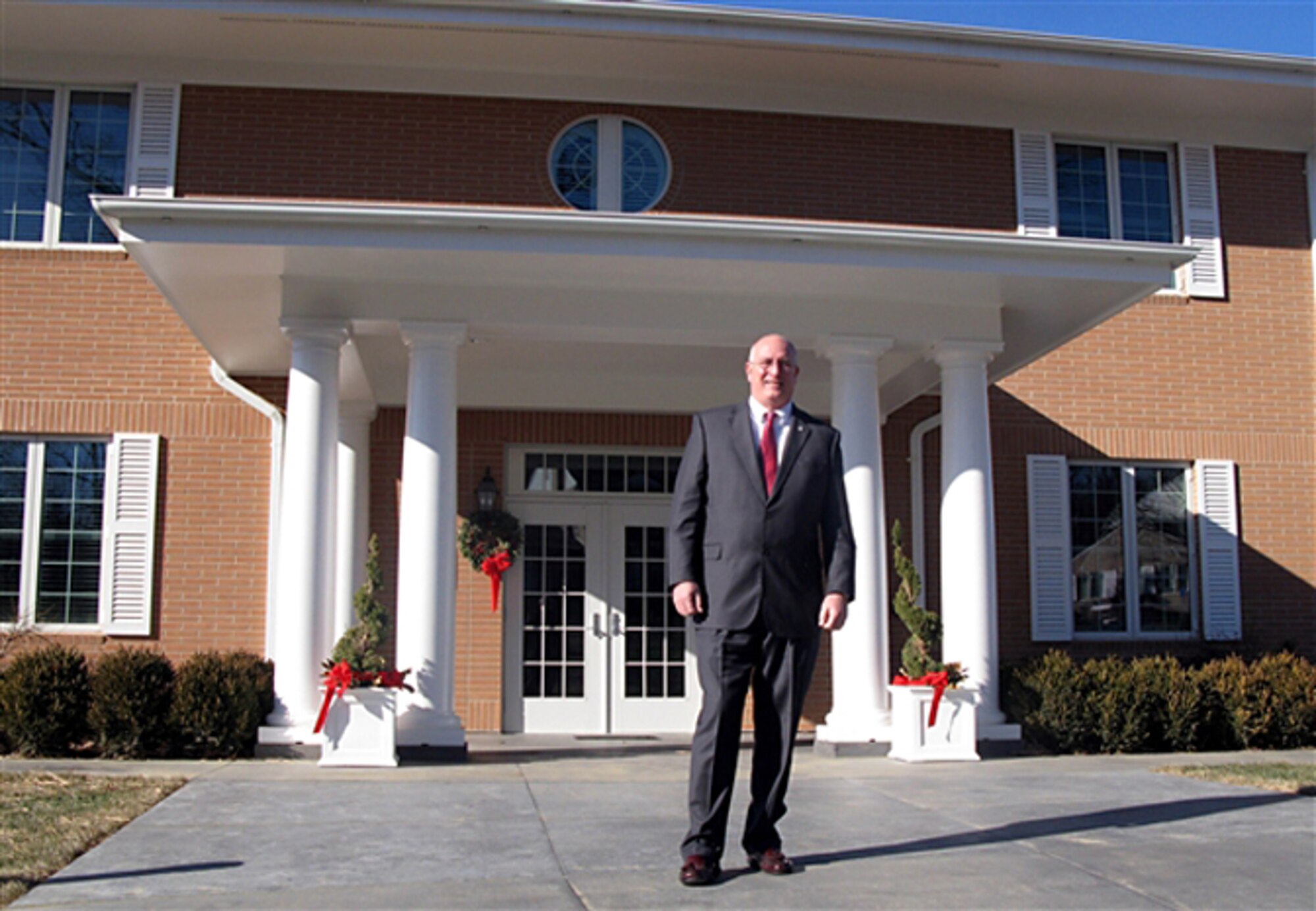 Dave Coker stands in front of one of three new Fisher Houses at the National Naval Medical Center in Bethesda, Md. Mr. Coker is the president of the Fisher House Foundation. (Department of Defense photo/Donna Miles)