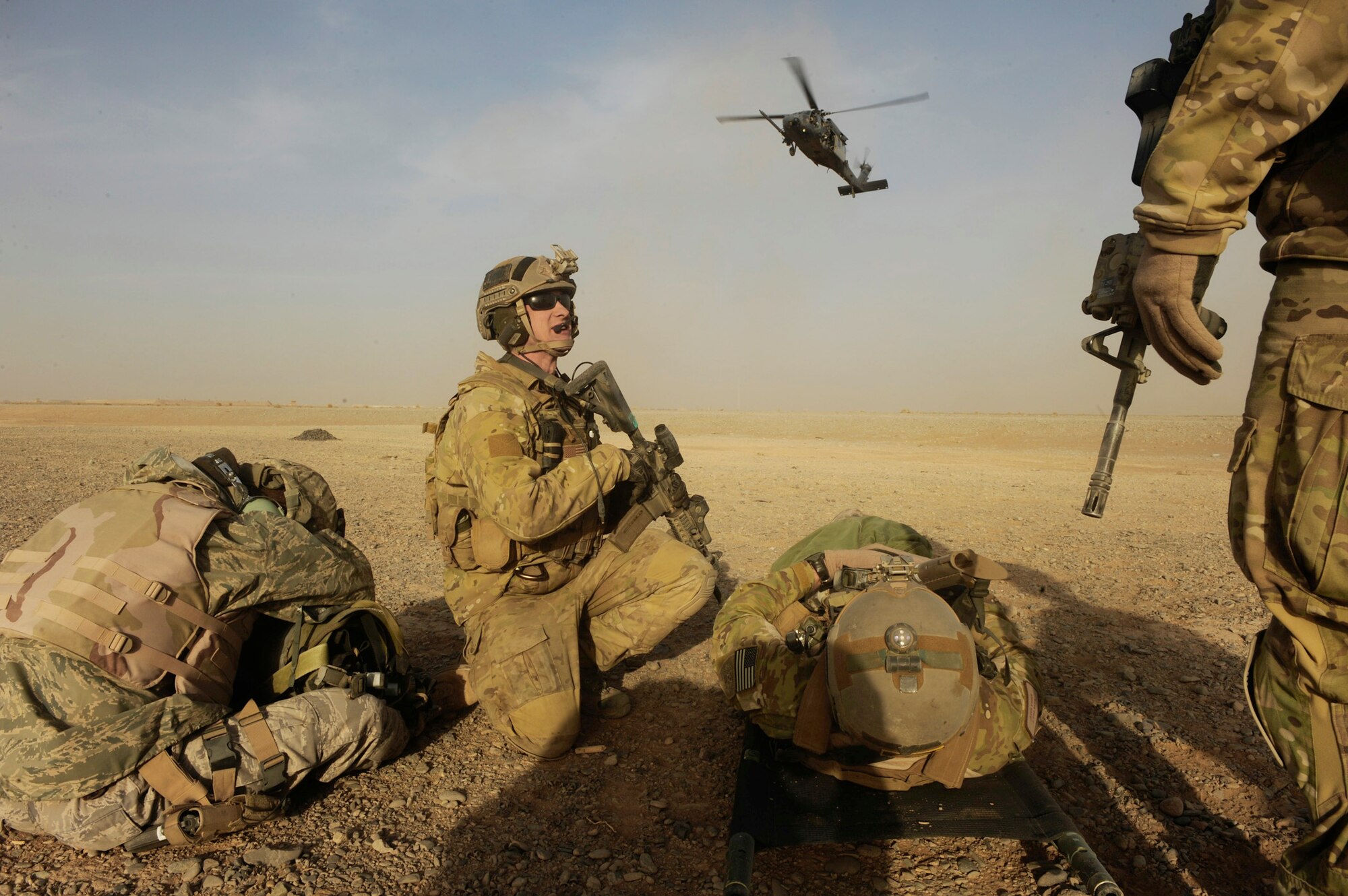 Capt. Nick Morgans prepares to load 'casualties' with other Airmen as an HH-60 Pave Hawk lands during a mass casualty scenario Dec. 24, 2010, near Kandahar, Afghanistan.  Sergeant Wood and Captain Morgans are assigned to the 46th Expeditionary Rescue Squadron. (U.S. Air Force photo/Staff Sgt. Eric Harris)  
