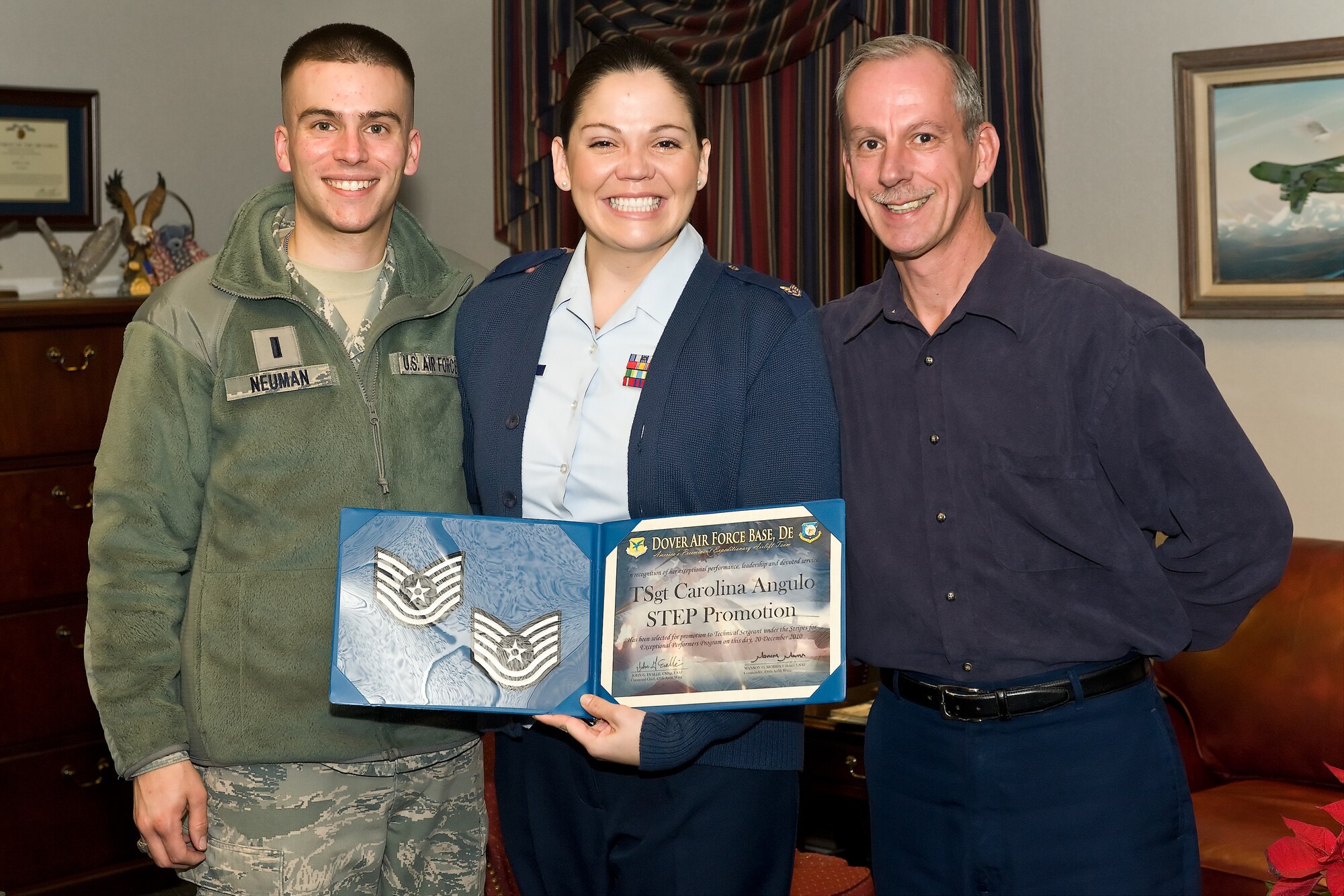 (UNRELEASED) Col. Manson Morris, commander, and Chief Master Sgt. John Evalle, Command Chief Master Sgt., of the 436th Airlift Wing, promote Staff Sgt. Carolina N. Angulo, 436th Airlift Wing Protocol, to Technical Sergeant through the Stripes for Exceptional Performers program on Monday, Dec. 20, 2010, Dover Air Force Base, Del. (U.S. Air Force photo/Roland Balik)