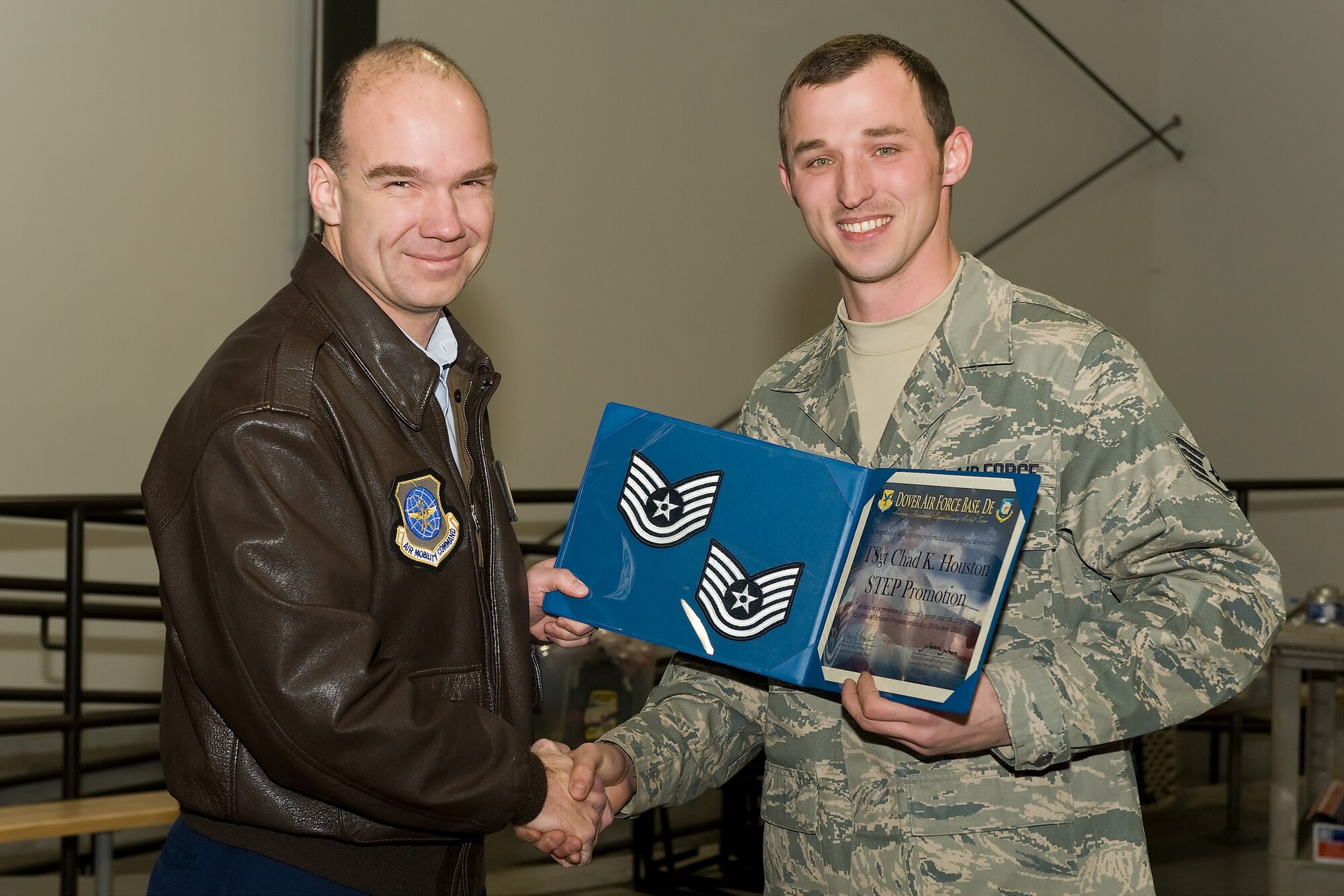 (UNRELEASED) Col. Manson Morris, commander, and Chief Master Sgt. John Evalle, Command Chief Master Sgt., of the 436th Airlift Wing, promote Staff Sgt. Chad K. Houston, 436th Aerial Port Squadron to Technical Sergeant through the Stripes for Exceptional Performers program on Monday, Dec. 20, 2010, Dover Air Force Base, Del. (U.S. Air Force photo/Roland Balik)