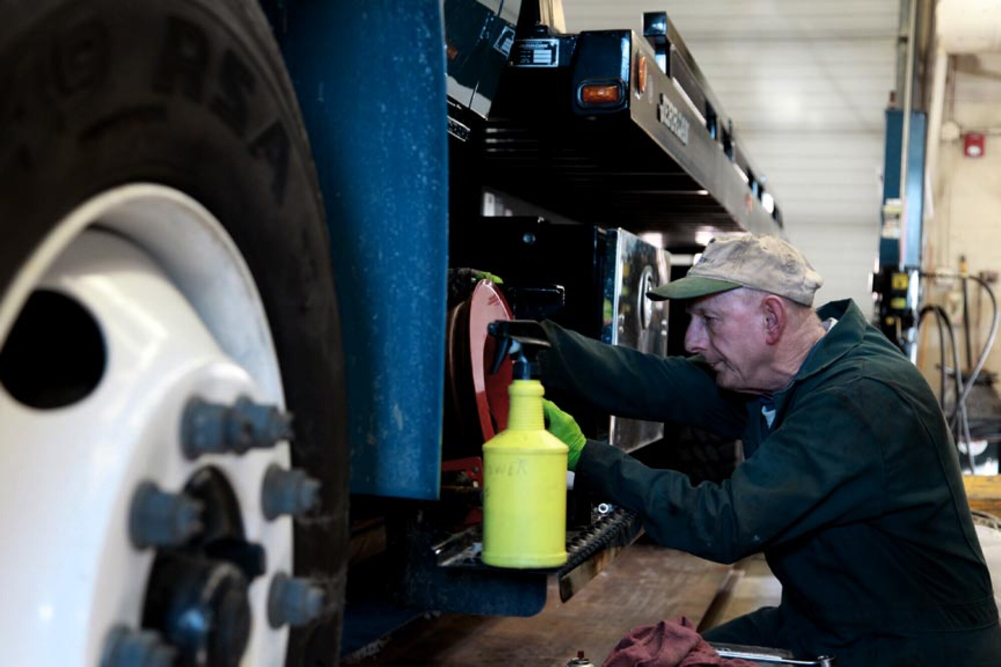 Bob Haines, a civilian mechanic employed by the contractor Maytag Aircraft, works on one of the two base sweeper trucks, Jan. 4.Henry Holland, a civilian mechanic employed by the contractor Maytag Aircraft, installs a new hose reel on an International DuraStar rollback in transportation’s garage, building 305, Jan. 4. Maytag Aircraft is a subcontractor of Santa Barbara Applied Research Inc. tasked with ensuring the upkeep of fuels, maintenance, and the airfield during the week when traditional reservists are not present.