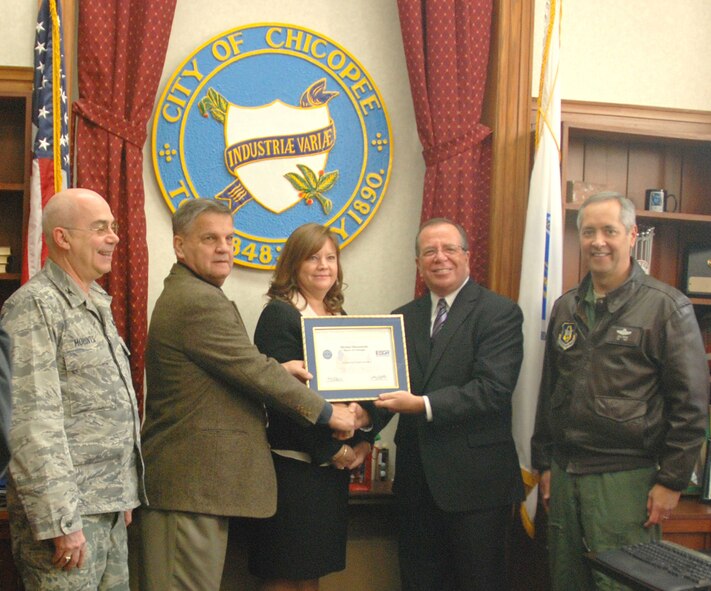 Michael Bissonnette, mayor of Chicopee, Mass., receives the Patriot Award from Earl Bonett, Massachusetts Employer Support for the Guard and Reserve ombudsman, Jan. 4, while surrounded by senior leaders from the 439th Airlift Wing. (US Air Force photo/Master Sgt. Andrew Biscoe) 
